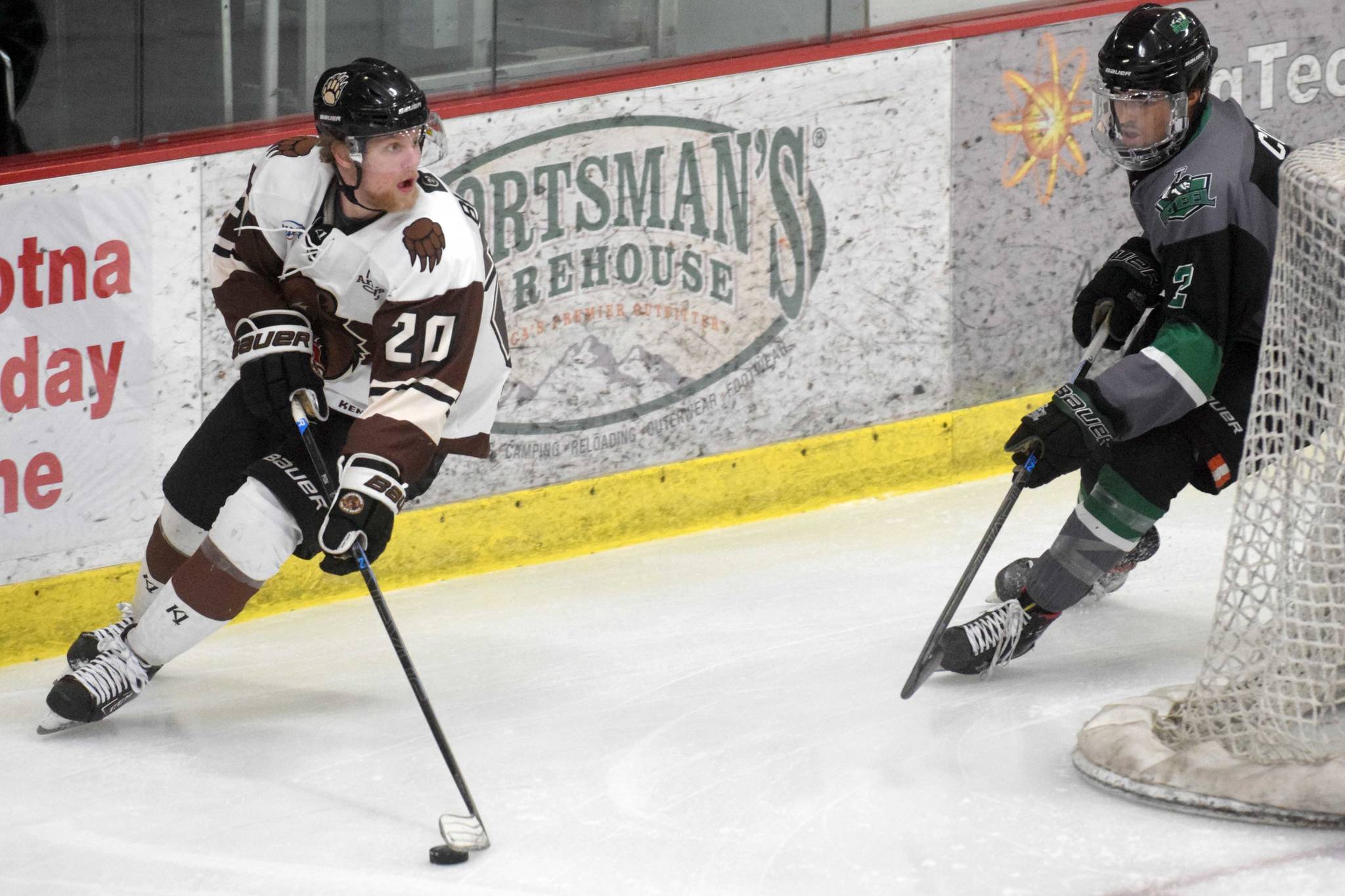 Kenai River Brown Bears forward Cam Blanton looks for an opening against Chippewa (Wisconsin) Steel defenseman Spencer Cox on Friday, April 23, 2021, at the Soldotna Regional Sports Complex. (Photo by Jeff Helminiak/Peninsula Clarion)