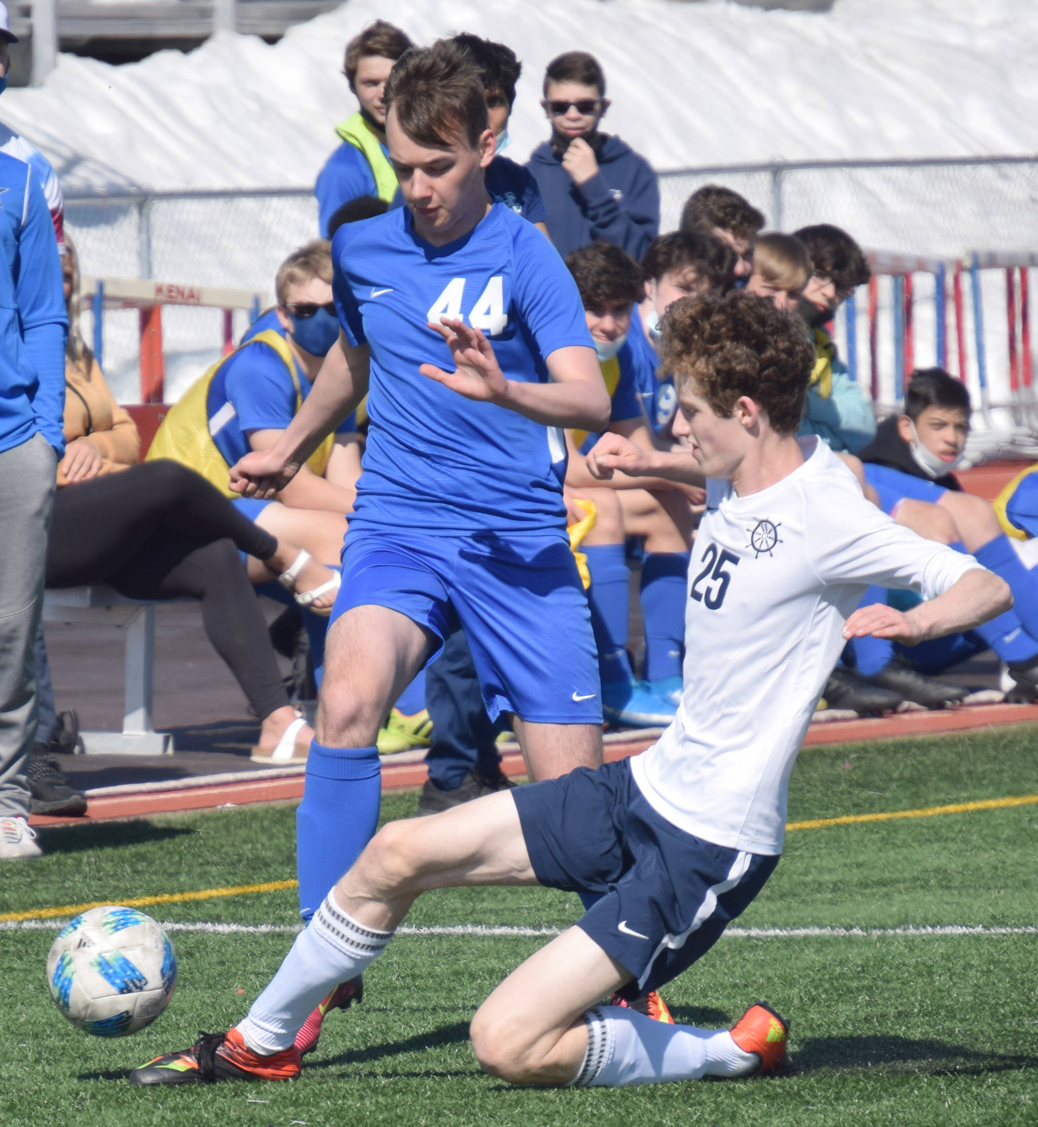 Homer’s Seamus McDonough tackles Soldotna’s Blaine Hayes on Saturday, April 24, 2021, at Kenai Central High School in Kenai, Alaska. (Photo by Jeff Helminiak/Peninsula Clarion)