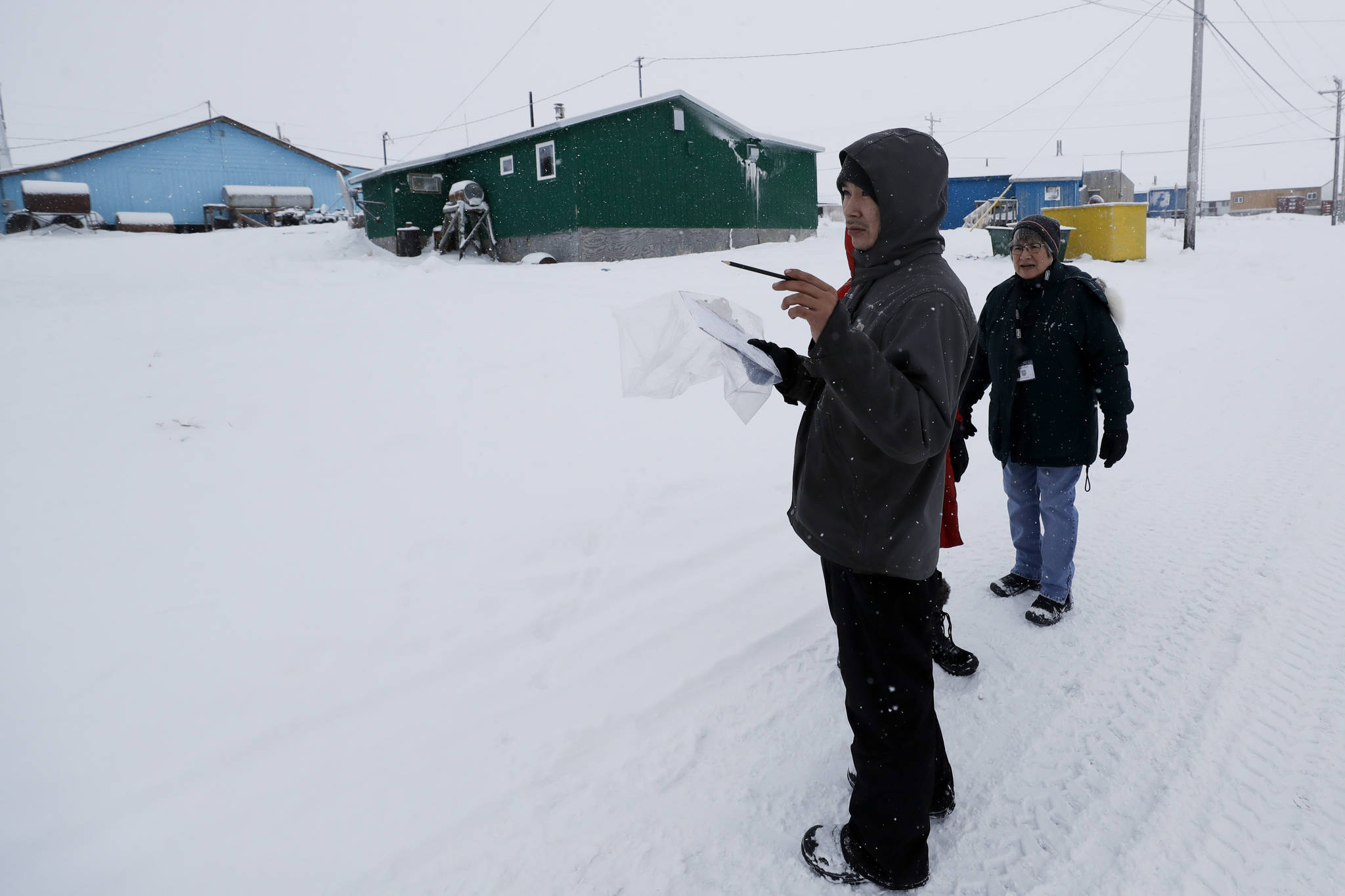 In this Jan. 20, 2020, file photo, census workers verify that their maps match up to the right amount of houses in Toksook Bay, Alaska, a mostly Yup’ik village on the edge of the Bering Sea. Alaska’s population grew by 23,160 people, or 3.3%, in the last decade, according to the first numbers released Monday for the 2020 Census. (AP Photo/Gregory Bull, File)