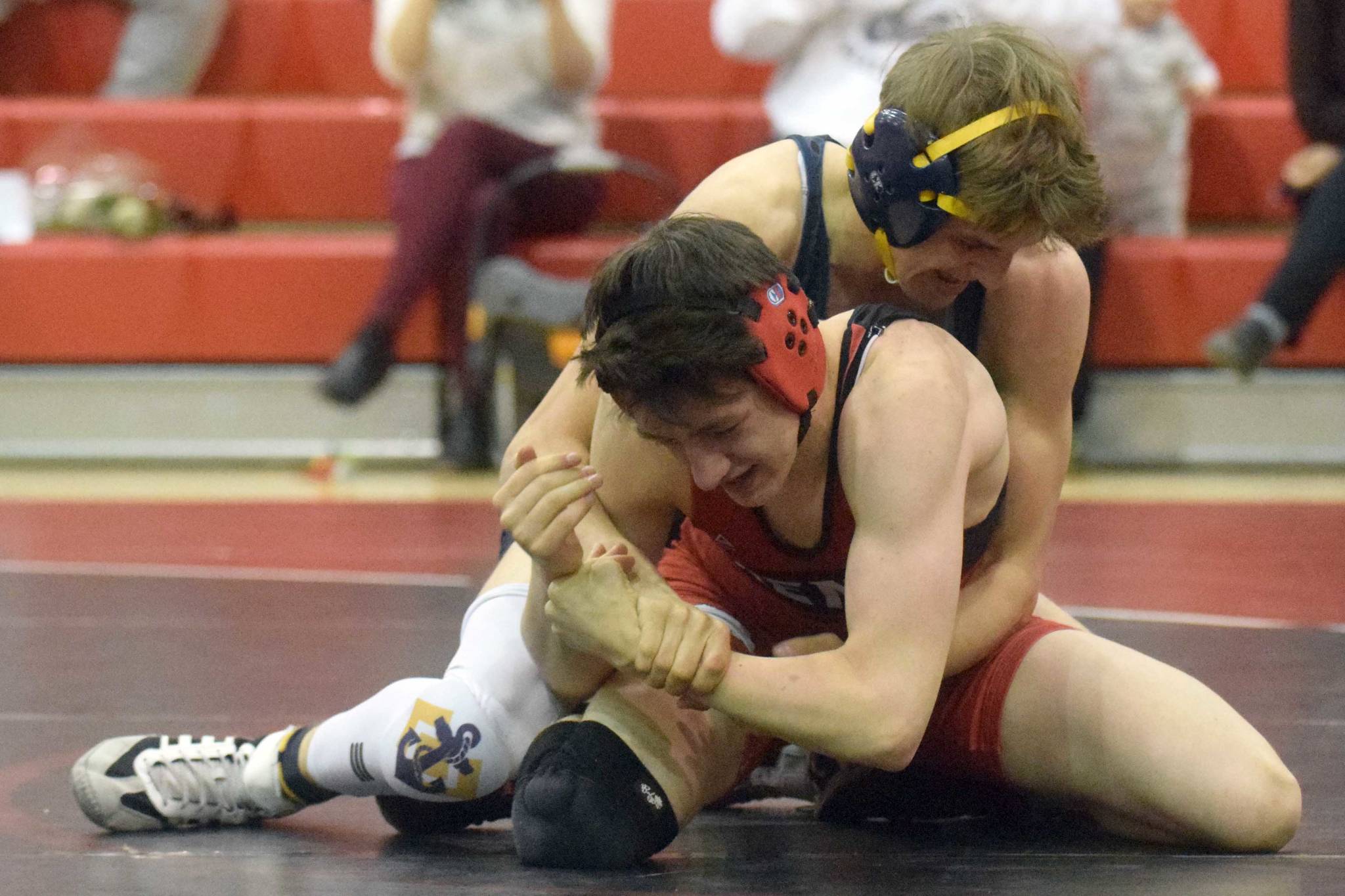 Homer's Austin Cline wrestles to a 20-13 decision over Kenai Central's Talon Whicker at 135 pounds Tuesday, April 27, 2021, at Kenai Central High School in Kenai, Alaska. (Photo by Jeff Helminiak/Peninsula Clarion)