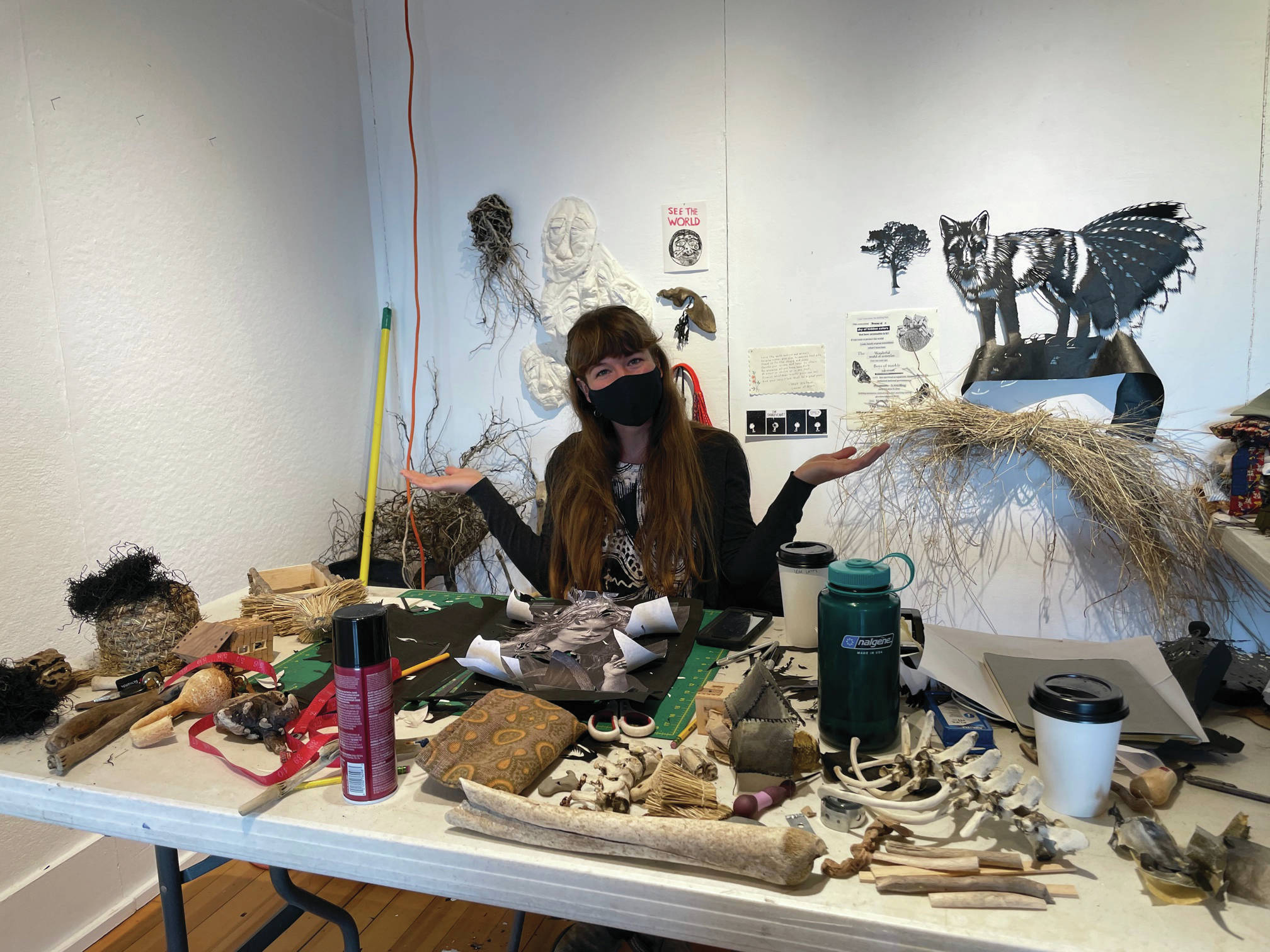 Artist-in-residence Emily Schubert makes sense out of her materials-covered desk on April at Bunnell Street Arts Center.