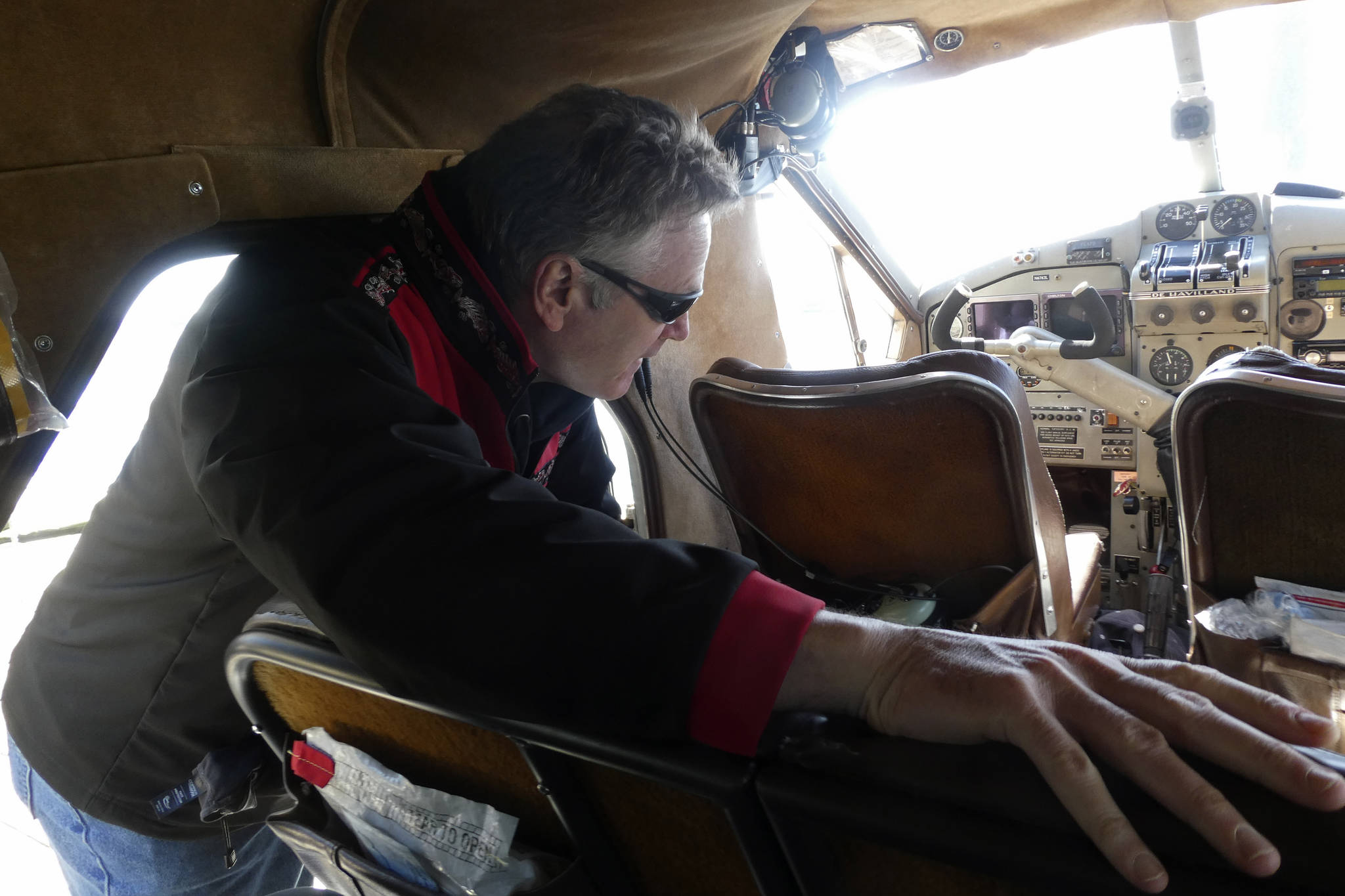 Alaska Gov. Mike Dunleavy climbs into a float plane in Ketchikan, Alaska, on Thursday, April 22, 2021, as he prepares to travel to the community of Hyder near the U.S.-Canada border. Dunleavy visited several southeast Alaska communities as part of a one-day trip. (AP Photo/Becky Bohrer)