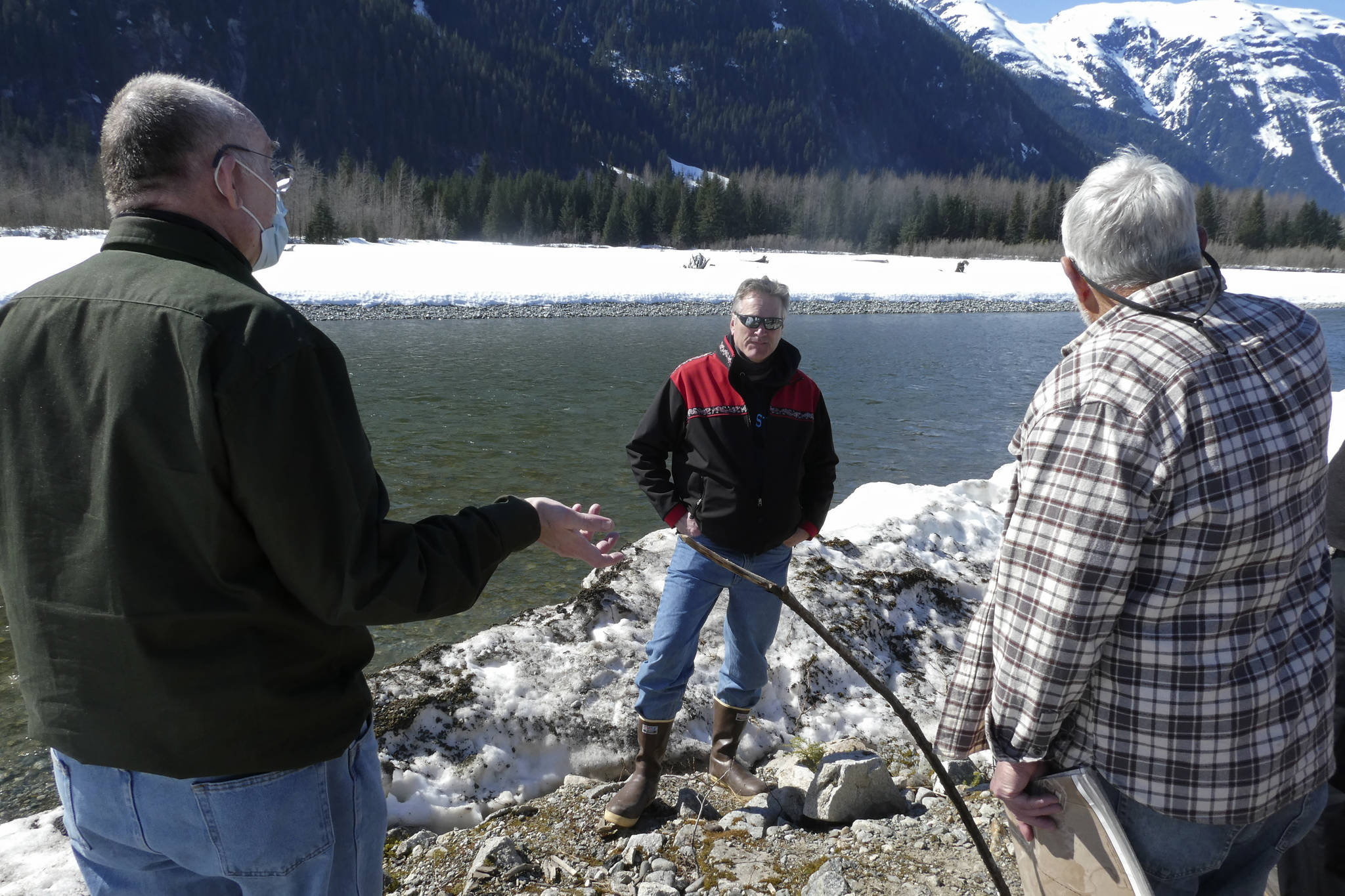 Alaska Gov. Mike Dunleavy, center, listens as residents discuss a levee they have concerns with on Thursday, April 22, 2021, in Hyder, Alaska. Hyder was among the southeast Alaska communities that Dunleavy visited as part of a one-day trip. (AP Photo/Becky Bohrer)
