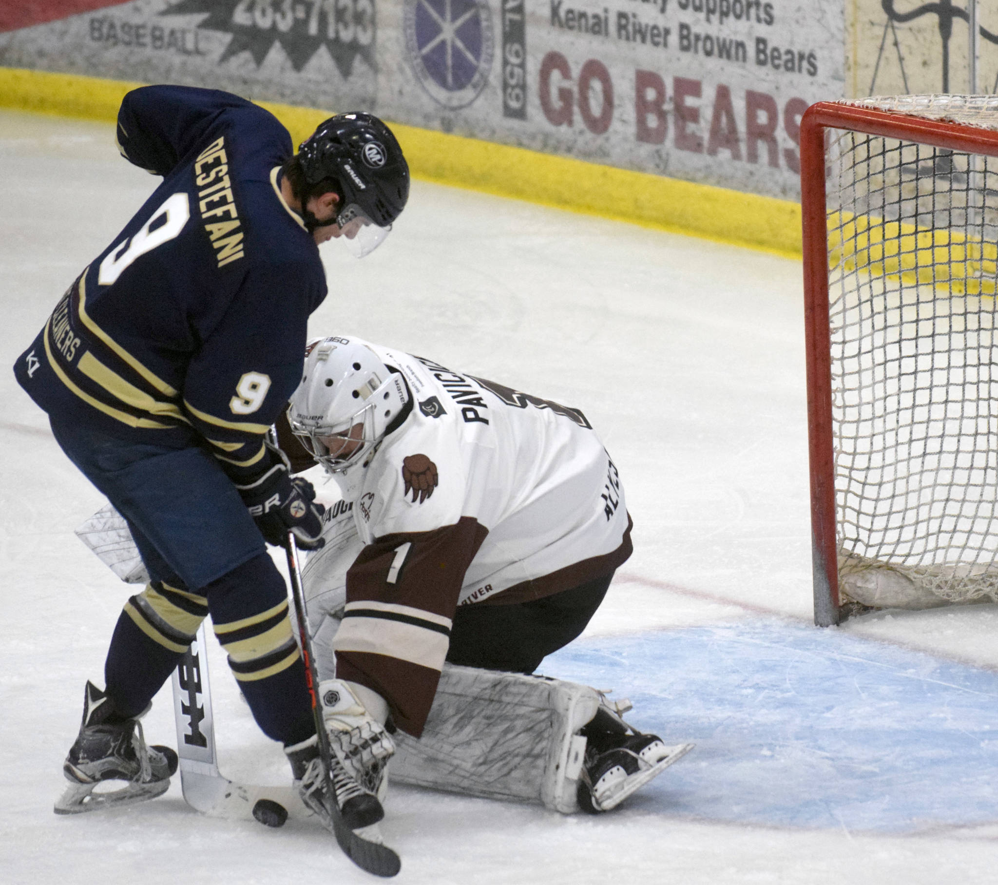 Kenai River Brown Bears goaltender Luke Pavicich stuffs Cade Destefani of the Janesville (Wisconsin) Jets on Friday, April 30, 2021, at the Soldotna Regional Sports Complex in Soldotna, Alaska. (Photo by Jeff Helminiak/Peninsula Clarion)