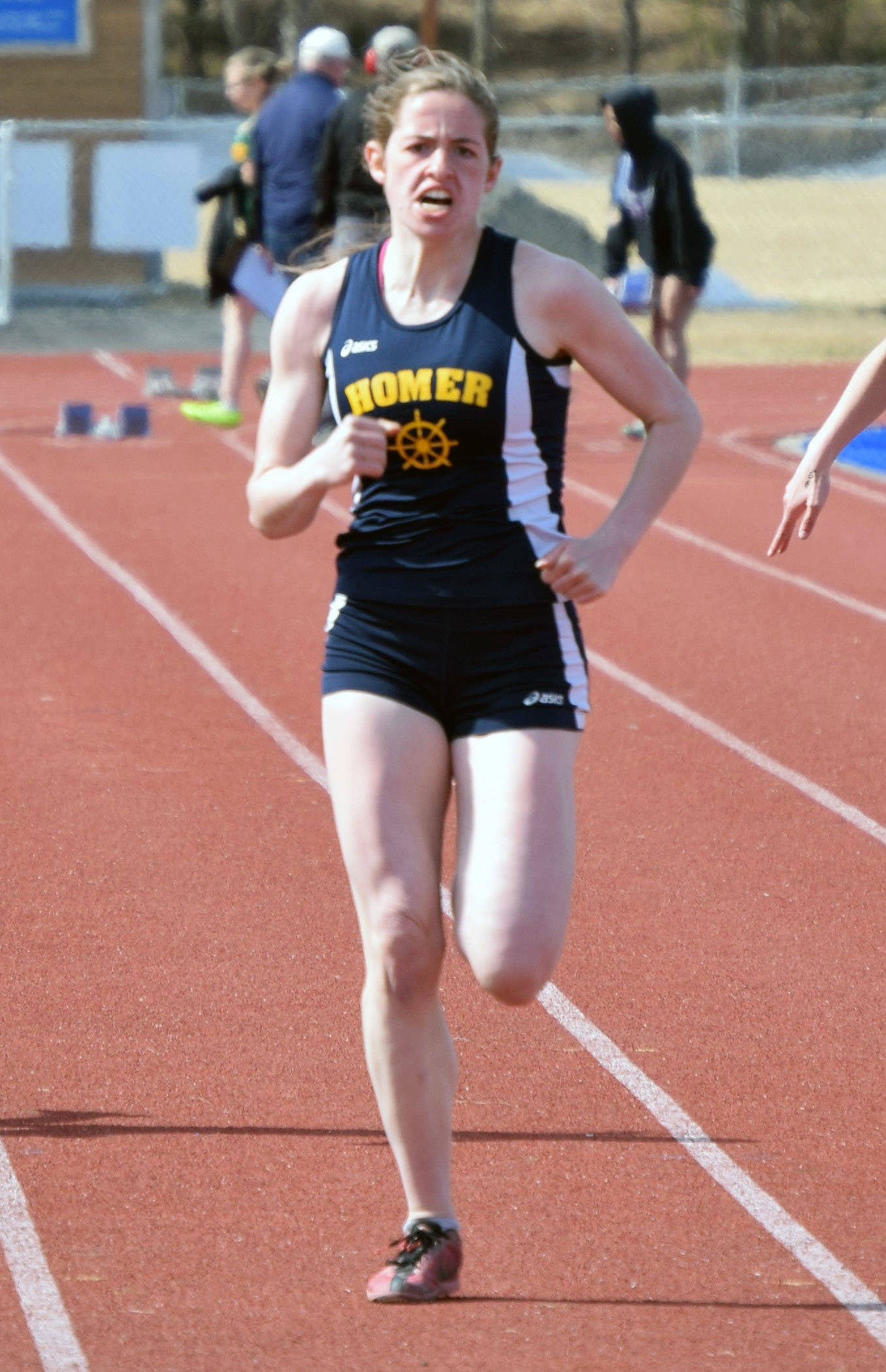 Homer’s Laura Inama runs to victory in the 100 meters at the SoHi Invitational on Saturday, May 1, 2021, at Soldotna High School in Soldotna, Alaska. (Photo by Jeff Helminiak/Peninsula Clarion)