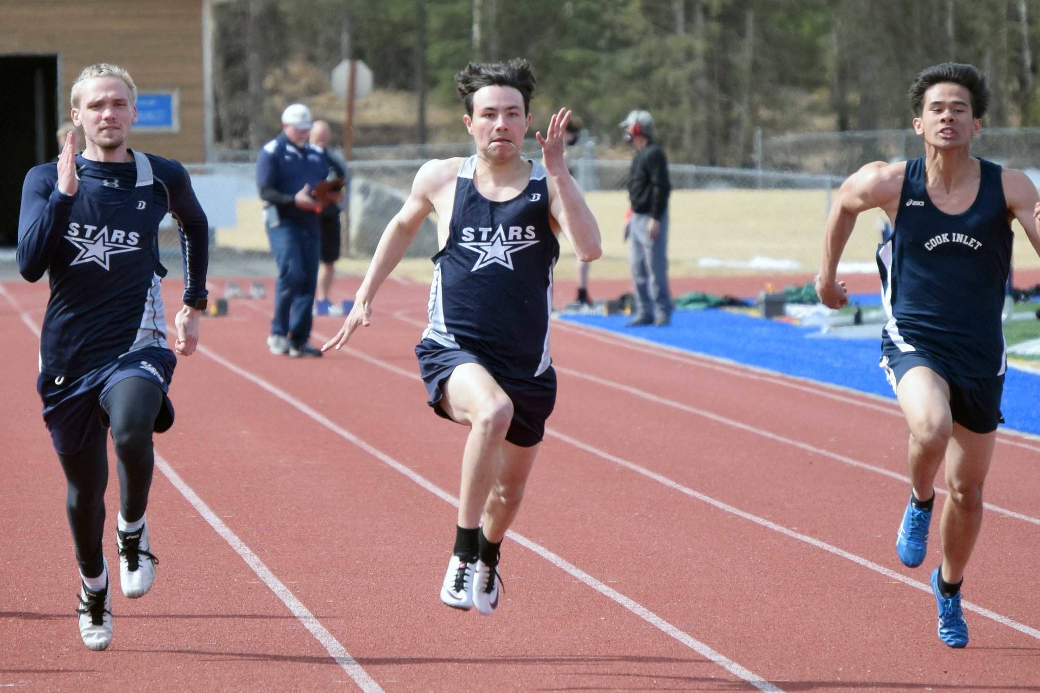 Soldotna Trenton O'Reagan (center) runs to victory in the 100 meters Saturday, May 1, 2021, at Soldotna High School in Soldotna, Alaska. (Photo by Jeff Helminiak/Peninsula Clarion)