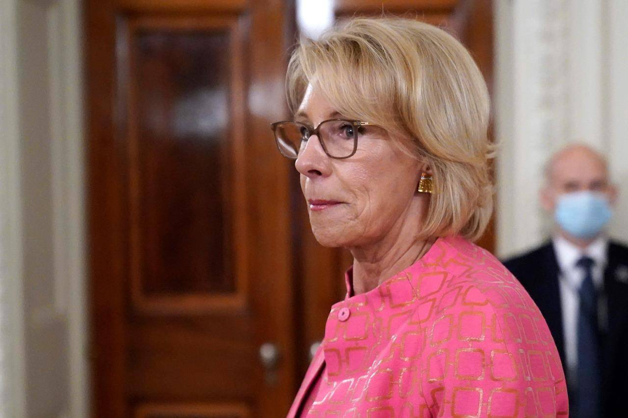 Education Secretary Betsy DeVos arrives for an event in the State Dining room of the White House, Wednesday, Aug. 12, 2020, in Washington. (AP Photo/Andrew Harnik, File)
