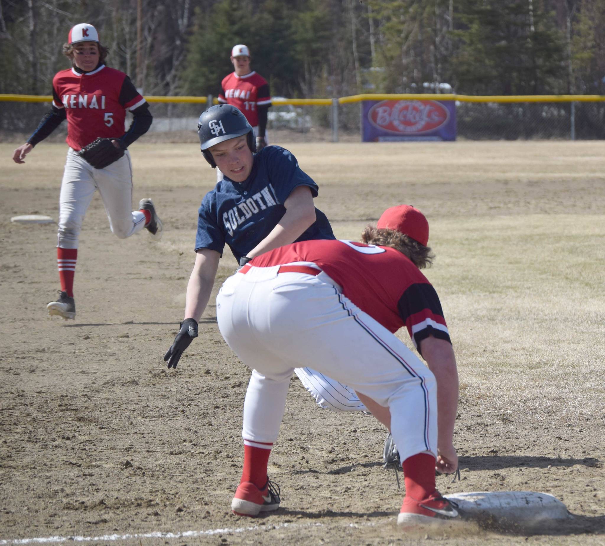 Kenai Central third baseman Charlie Chamberlain gets ready to tag out Soldotna’s Dylan Davidhizar on Tuesday, May 4, 2021, at the Soldotna Little League fields in Soldotna, Alaska. (Photo by Jeff Helminiak/Peninsula Clarion)