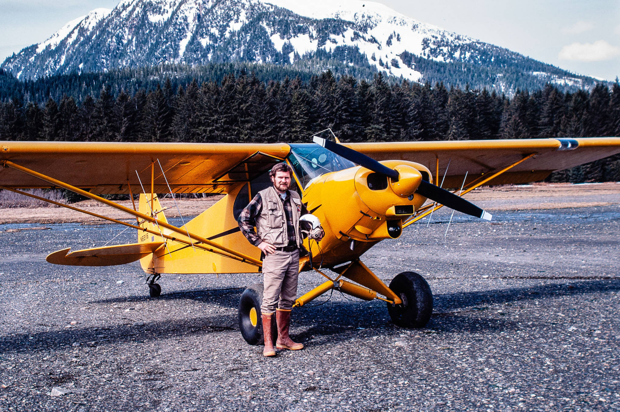 Biologist John Schoen with the Super Cub on a beach on Admiralty Island. The two antennas under each wing were used to determine which direction had the strongest signal from radio-collared animals. They then could locate the animals within an area about the size of an acre. (Photo by John Schoen)