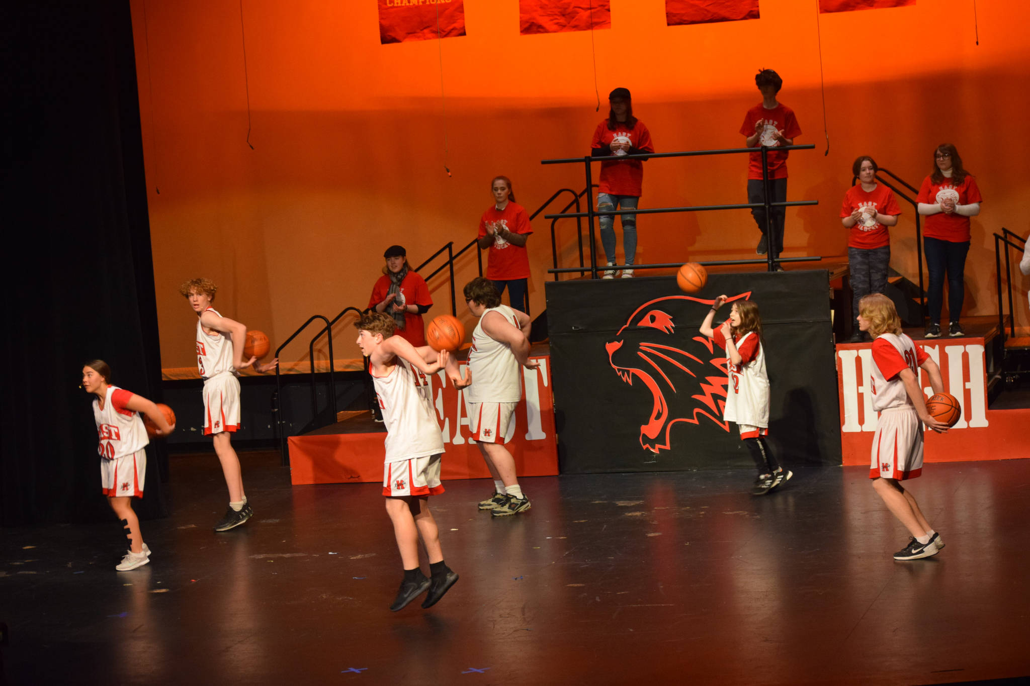 The cast of Nikiski Middle/High School’s spring production of “High School Musical” sing onstage as their characters in Nikiski, Alaska, on Wednesday May 5, 2021. (Camille Botello / Peninsula Clarion)