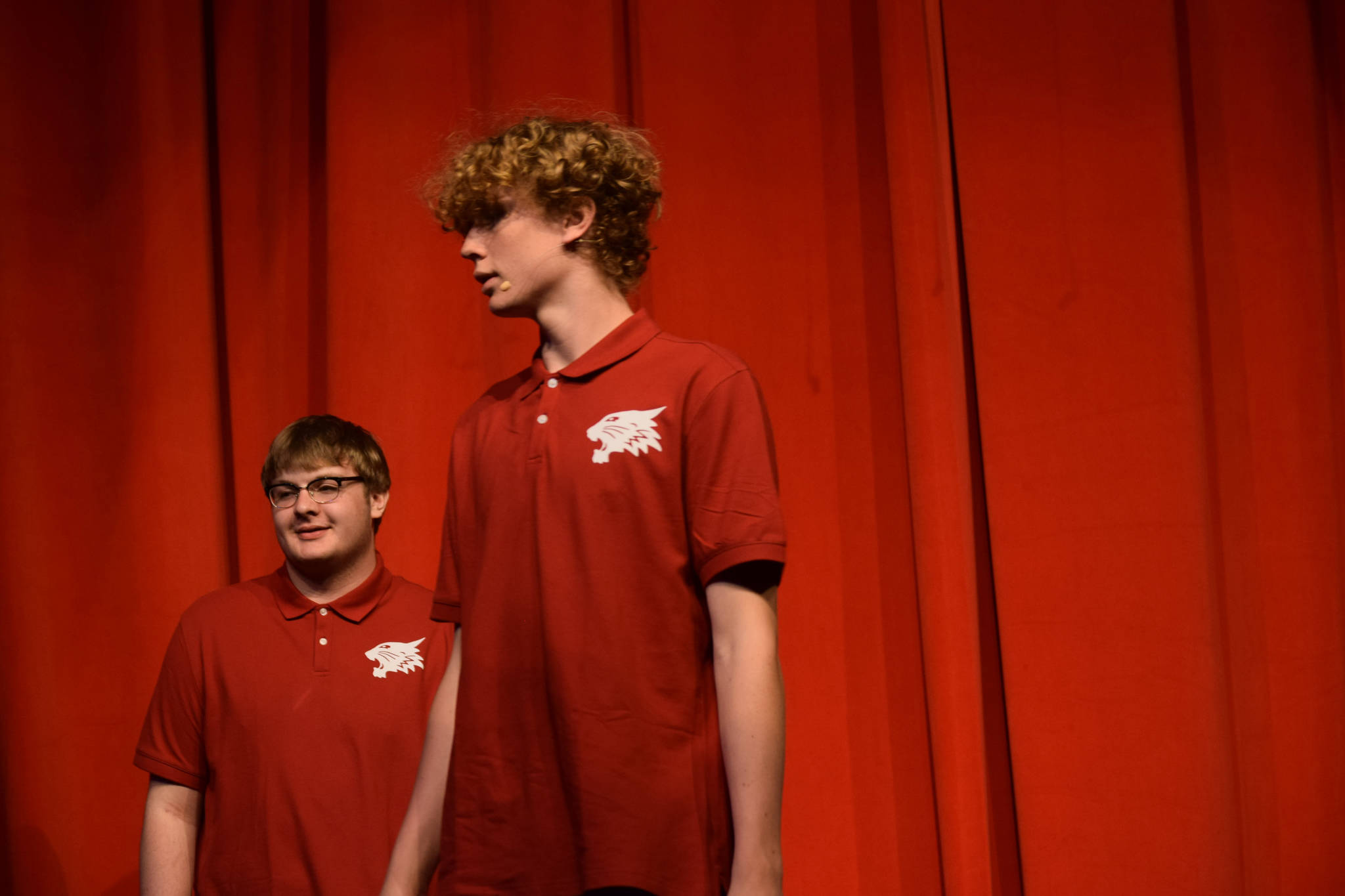 Foreground: Brady Bostic sings onstage as his character Chad Danforth in the Nikiski Middle/High School’s spring production of “High School Musical” in Nikiski, Alaska, on Wednesday May 5, 2021. (Camille Botello / Peninsula Clarion)