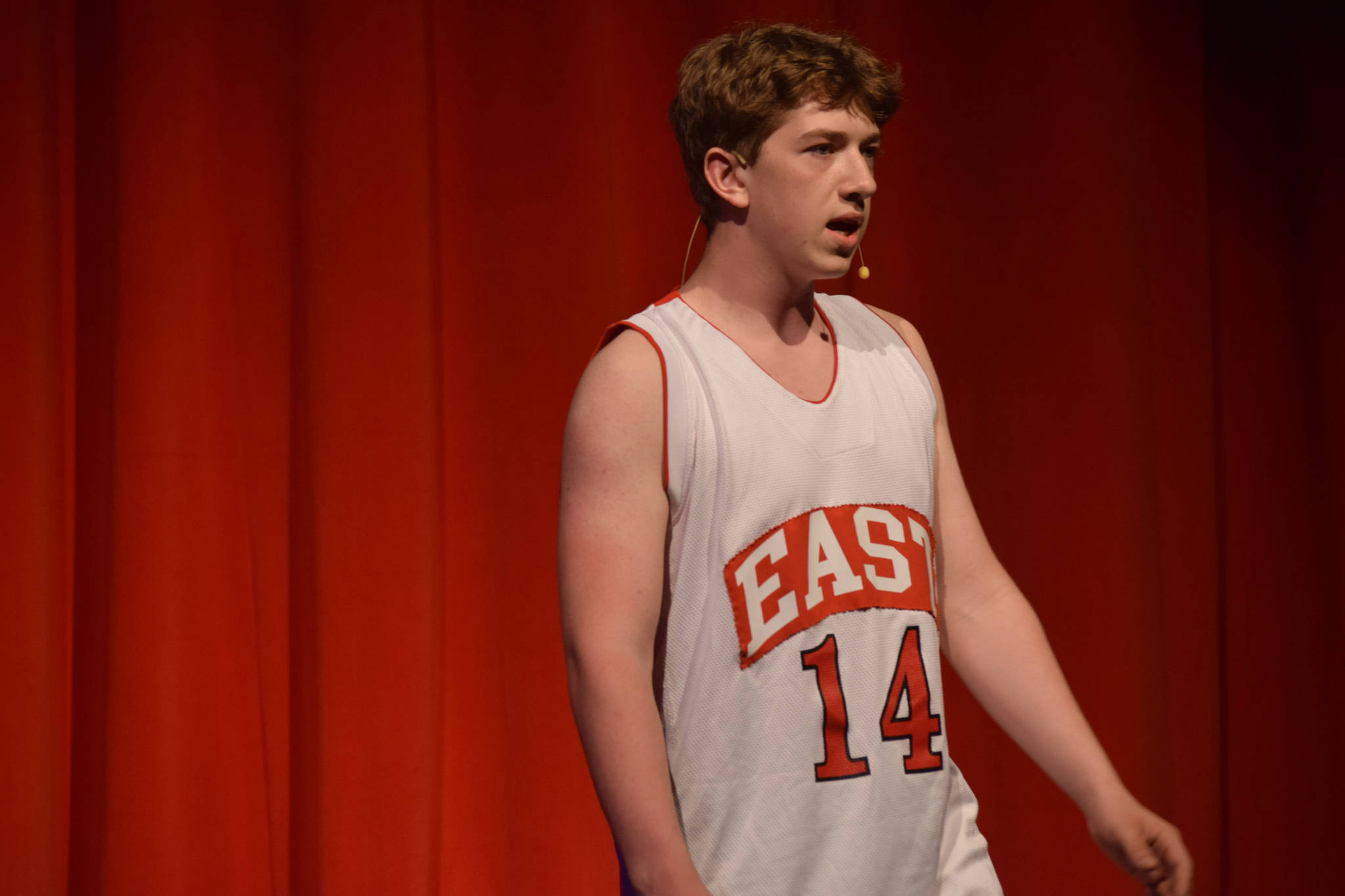 Braeden Porter sings onstage as his character Troy Bolton in the Nikiski Middle/High School’s spring production of “High School Musical” in Nikiski, Alaska, on Wednesday May 5, 2021. (Camille Botello / Peninsula Clarion)