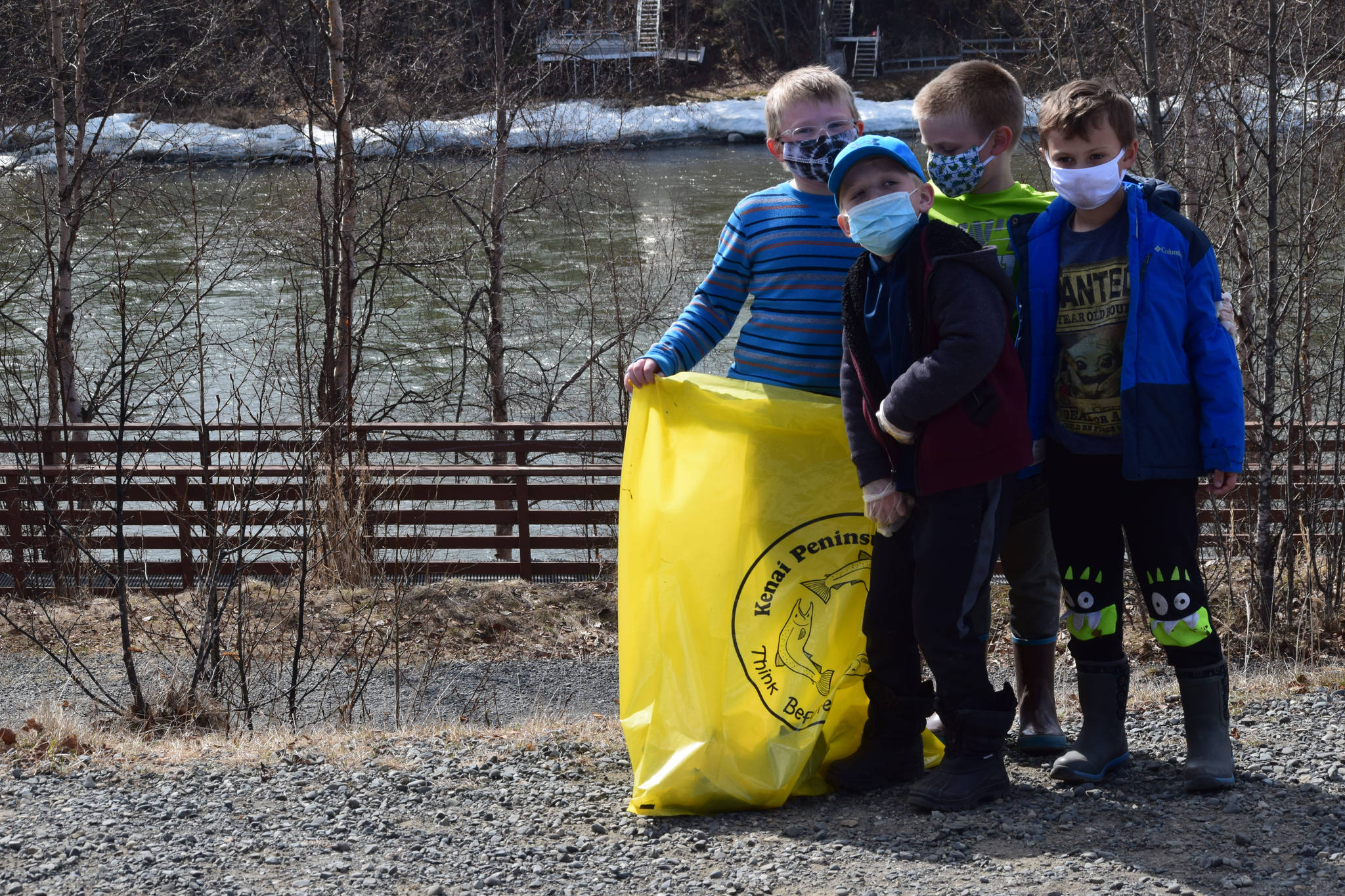 From left to right: Soldotna Montessori elementary schoolers Augie Mohr, Corbin Sulley, Nathan Nelson and Kian Jester participate in the annual Kenai River Spring Cleanup at Soldotna Creek Park in Soldotna, Alaska, on Friday, May 7, 2021. (Camille Botello / Peninsula Clarion)