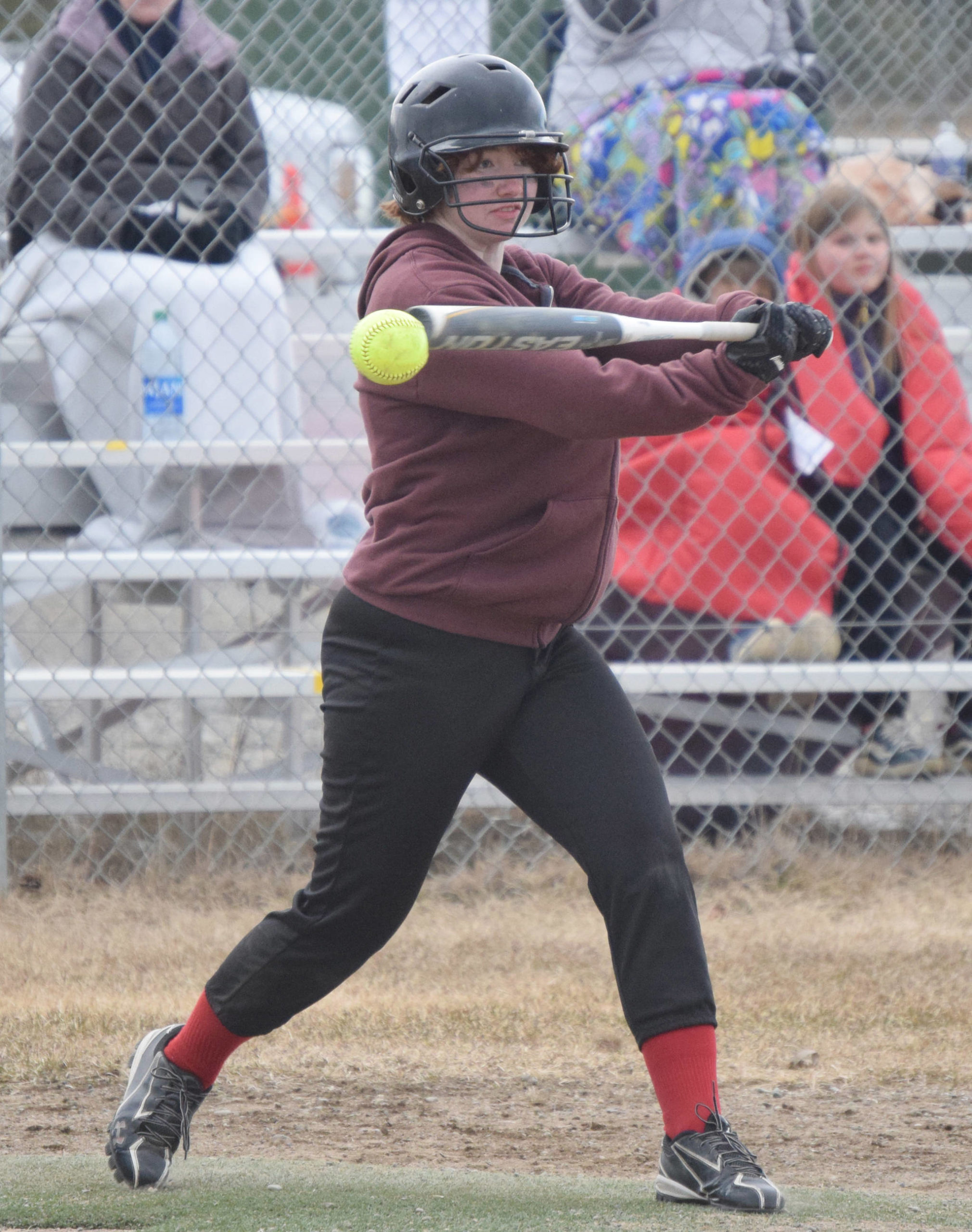 Kenai Centrals Caitlin Crabb fouls off a pitch against Kodiak on Friday, May 7, 2021, in Kenai, Alaska. (Photo by Jeff Helminiak/Peninsula Clarion)