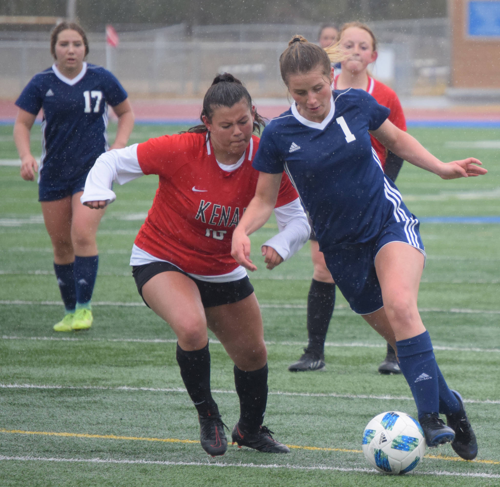 Soldotna’s Rhys Cannava dribbles in for a goal against Kenai Central’s Valerie Villegas on Tuesday, May 11, 2021, at Soldotna High School in Soldotna, Alaska. (Photo by Jeff Helminiak/Peninsula Clarion)