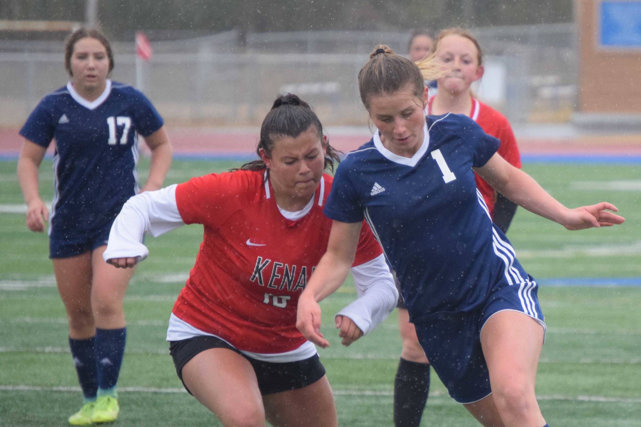 Soldotna's Rhys Cannava dribbles in for a goal against Kenai Central's Valerie Villegas on Tuesday, May 11, 2021, at Soldotna High School in Soldotna, Alaska. (Photo by Jeff Helminiak/Peninsula Clarion)