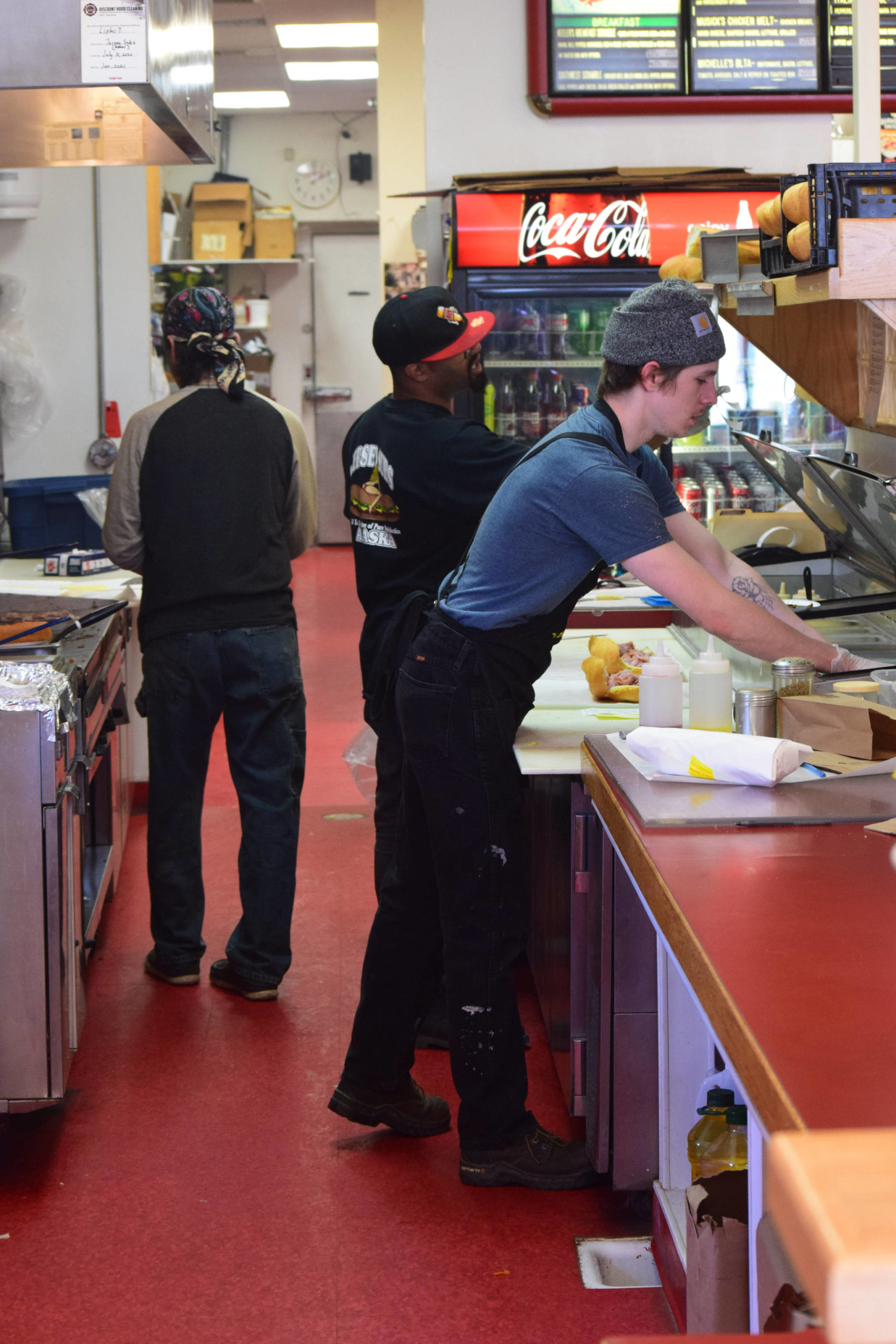 Employees work the lunch rush at Jersey Subs in Kenai, Alaska on Thursday, May 13, 2021. The sandwich shop is having trouble finding people to work this summer. (Camille Botello / Peninsula Clarion)