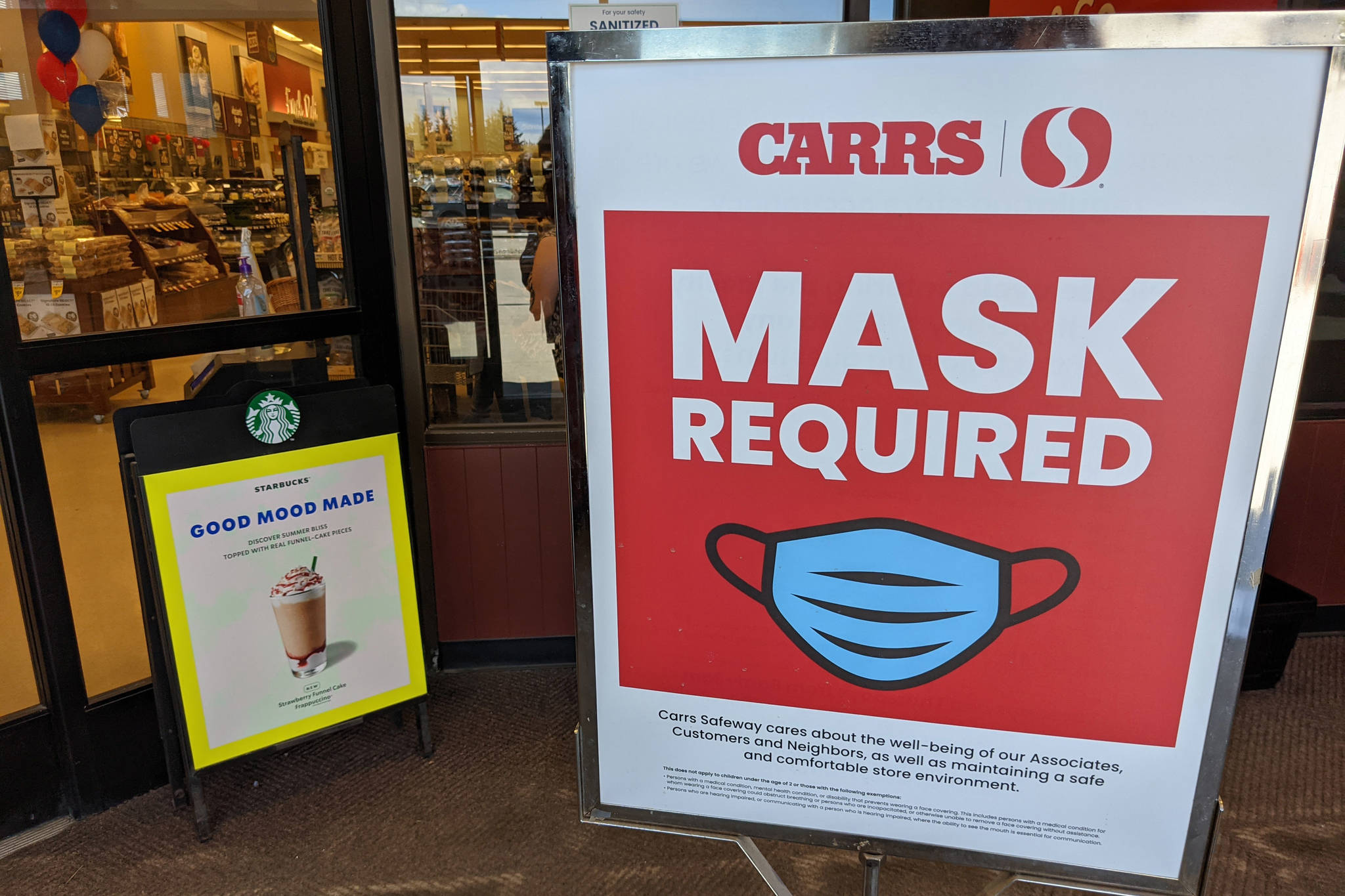 A sign explaining mask policy can be seen at Safeway grocery store in Kenai, Alaska, on Thursday, May 13, 2021. (Photo by Erin Thompson/Peninsula Clarion)