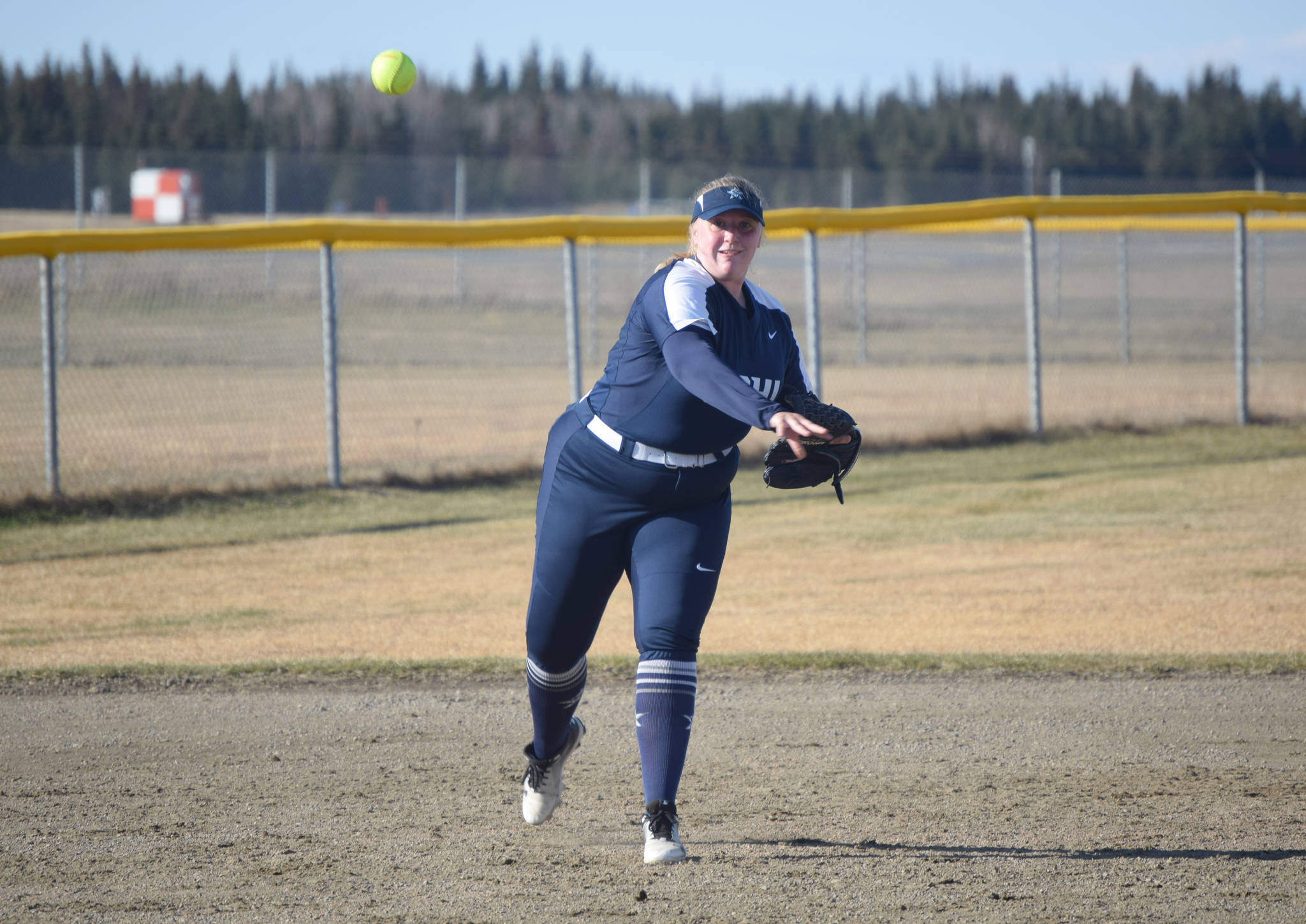 Soldotna’s Ashlyn Asp throws out a Kenai Central runner at first Thursday, May 13, 2021, in Kenai, Alaska. (Photo by Jeff Helminiak/Peninsula Clarion)