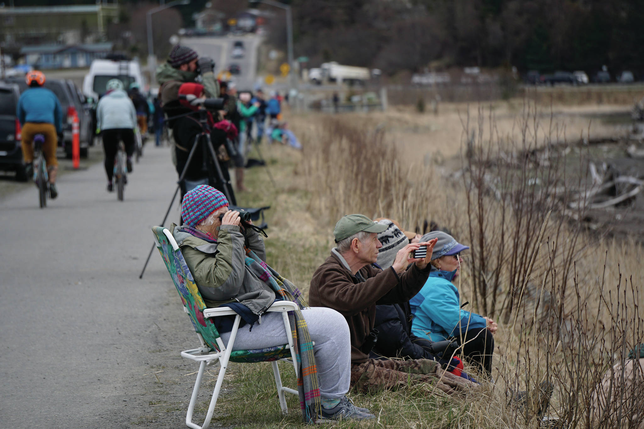 Birders check out shorebirds on the outgoing tide on Saturday, May 8, 2021, at Mud Bay on the Homer Spit in Homer, Alaska. (Photo by Michael Armstrong/Homer News)