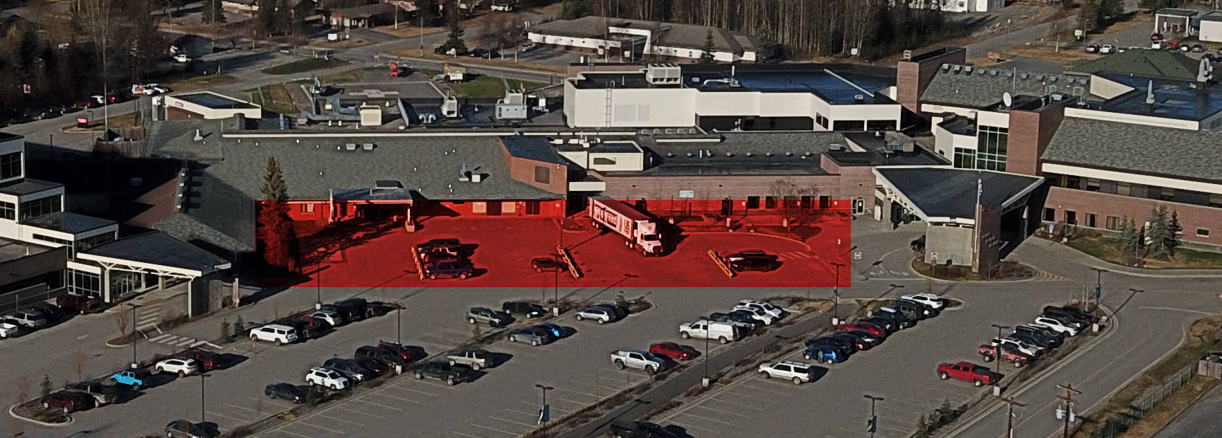 A parking lot set to be reconstructed is seen highlighted in red at Central Peninsula Hospital in Soldotna, Alaska. (Photo by Bruce Richards)