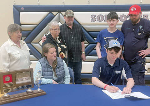 Soldotna senior Josh Tree signs his National Letter of Intent in front of family recently at Soldotna High School in Soldotna, Alaska. (Photo by Jeff Helminiak/Peninsula Clarion)