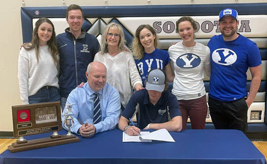 Soldotna senior Dylan Walton signs his National Letter of Intent as his family looks on recently at Soldotna High School in Soldotna, Alaska. (Photo by Jeff Helminiak/Peninsula Clarion)
