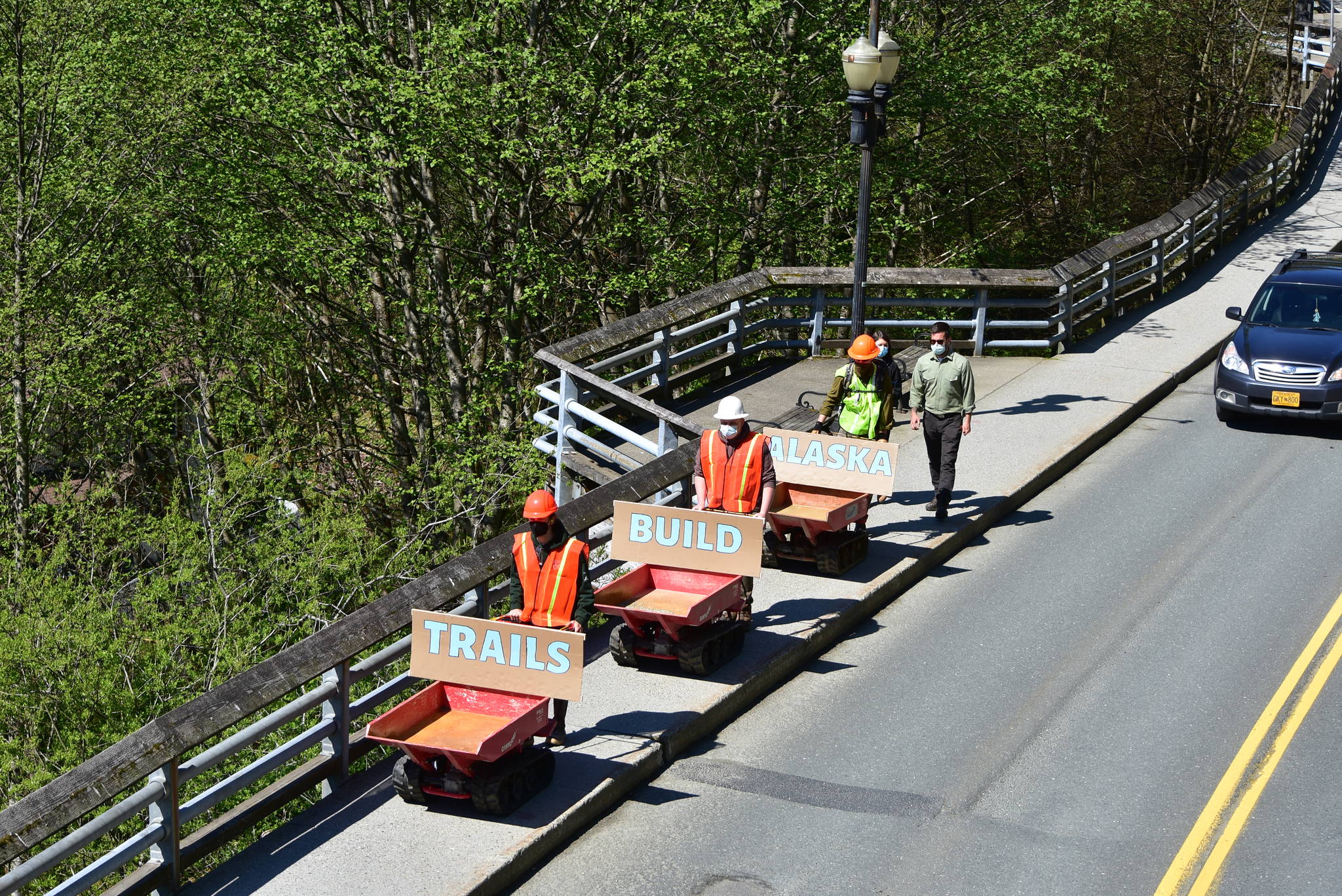 Track carriers used by trail builders to move gravel and dirt rumbled slowly down Calhoun Avenue on Tuesday, May 18, 2021, as supporters of conservation corps programs demonstrated from the Governor’s Mansion to the Alaska State Capitol. (Peter Segall / Juneau Empire)