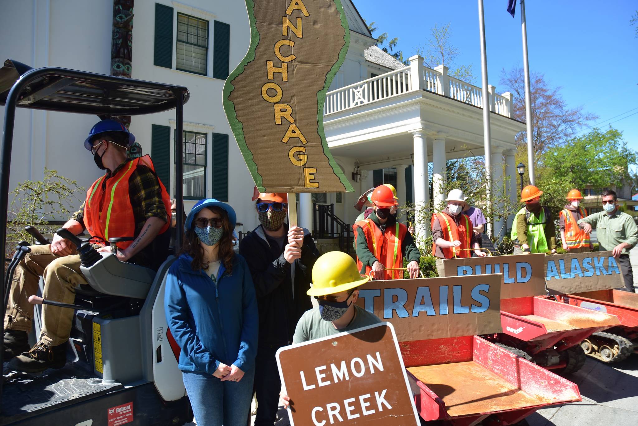 Supporters of the trail-building conservation corps started with CARES Act funding rallied in front of the Governor's Mansion on Tuesday, May 18, 2021, to urge state officials to continue funding the programs. (Peter Segall / Juneau Empire)