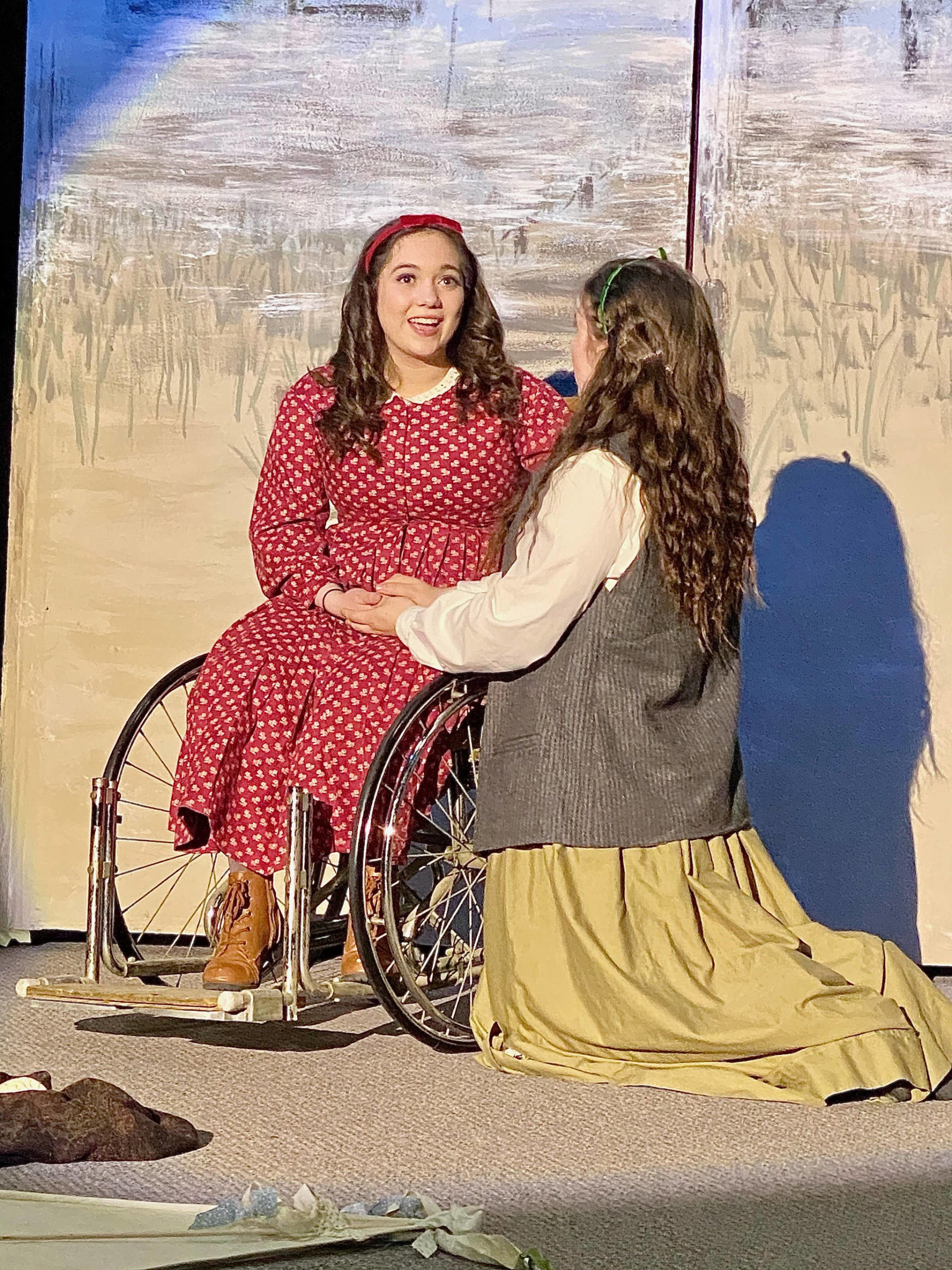 Jayni Parish (left) and Brittany Gilman act onstage as their characters Beth and Jo March in the Kenai Performers’ production of “Little Women,” which premieres on Thursday, May 20, 2021. (Photo provided)