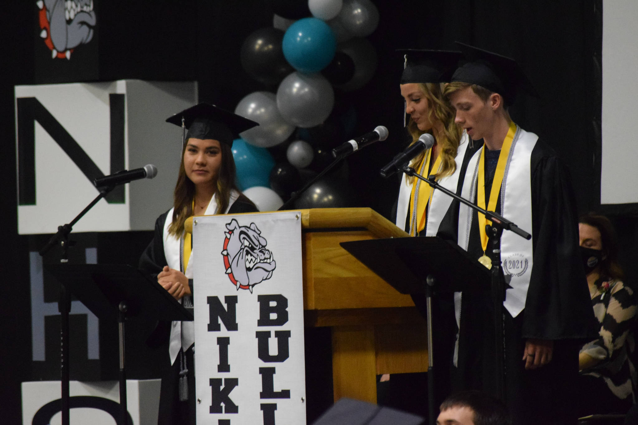 Valedictorians Rosalie Anderson, Lillian Carstens and Samuel Smith give their commencement address at the Nikiski Middle/High School graduation on Wednesday, May 19, 2021 in the gymnasium. (Camille Botello / Peninsula Clarion)