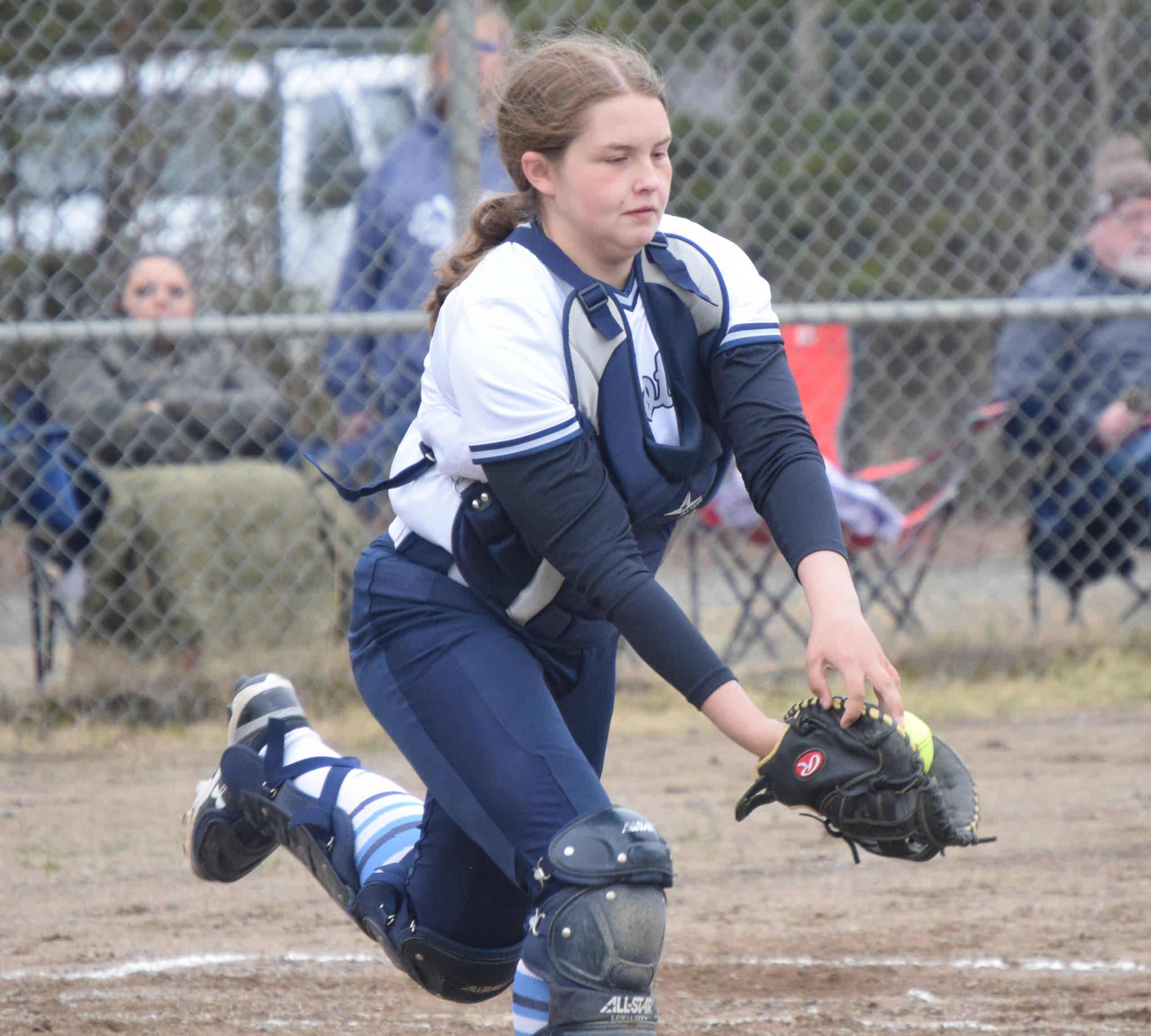 Soldotna catcher Bailey Conner stretches for a pop fly Thrusday, May 20, 2021, against Homer in Soldotna, Alaska. The ball popped out of the glove and was ruled a foul ball. (Photo by Jeff Helminiak/Peninsula Clarion)
