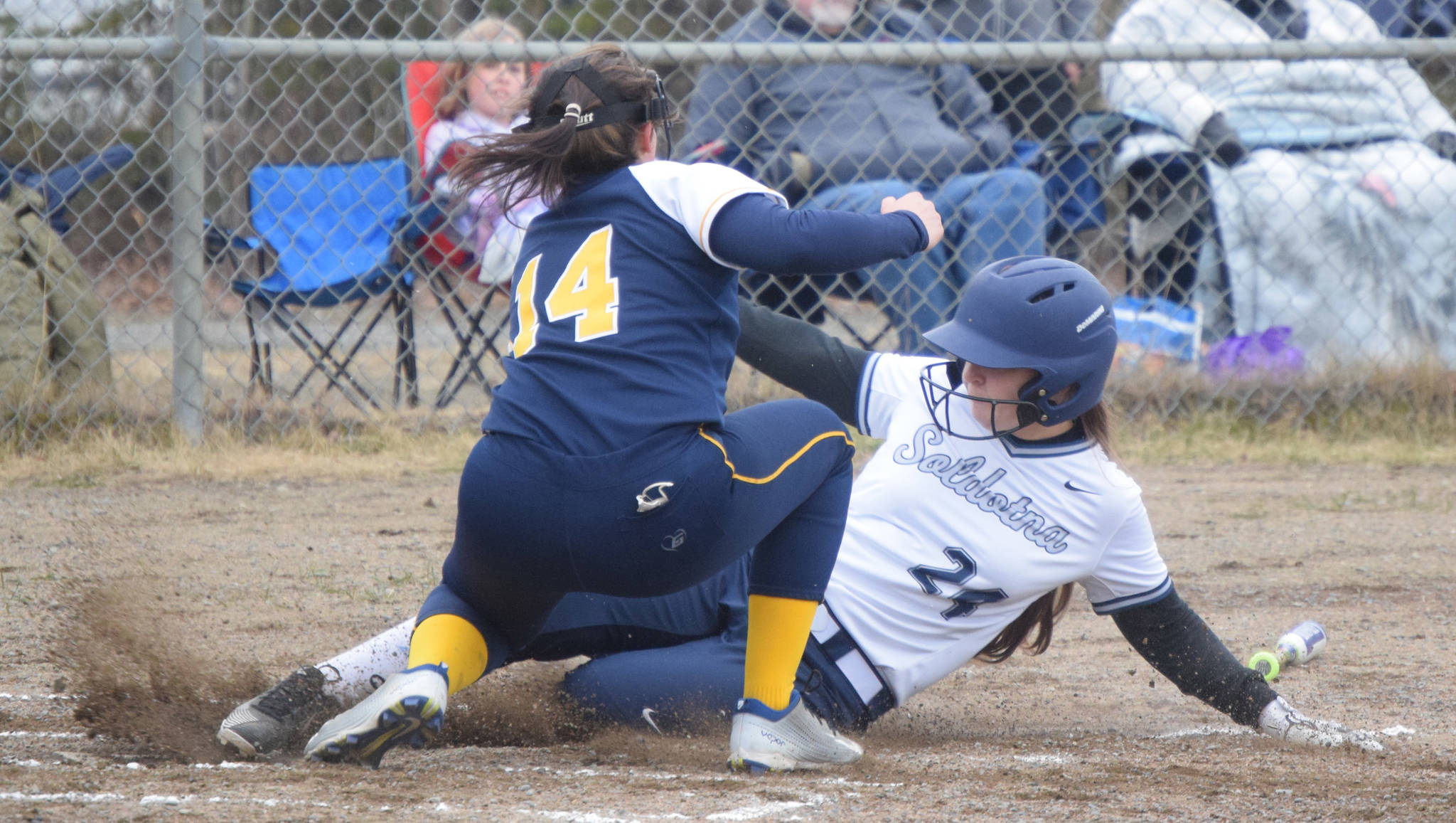 Soldotna’s Lexi Stormo slides under the tag of Homer pitcher Zoe Adkins on Thursday, May 20, 2021, in Soldotna, Alaska. (Photo by Jeff Helminiak/Peninsula Clarion)