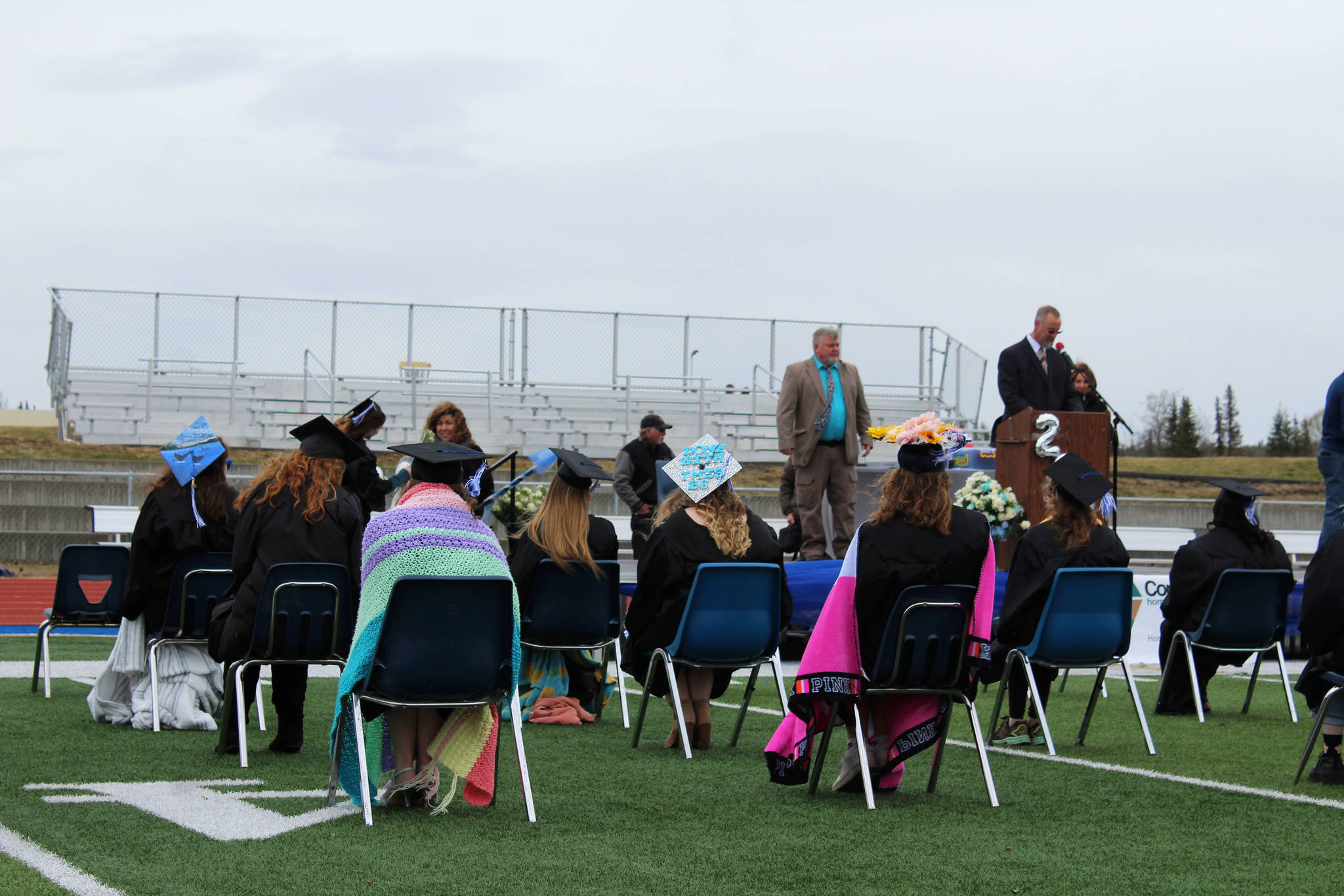 Graduates wear blankets during Connections Alaska Homeschool Programs 2021 graduation on Thursday, May 20, 2021 at Soldotna High School in Soldotna, Alaska. (Ashlyn OHara/Peninsula Clarion)