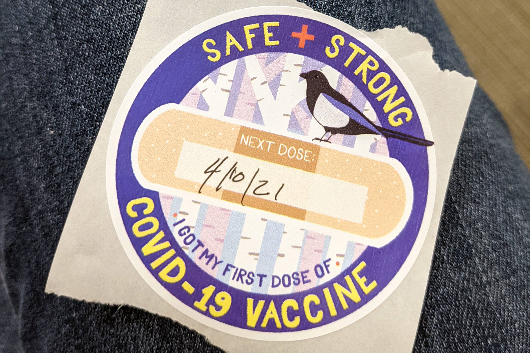 A sticker given out at a COVID-19 vaccination clinic hosted by the Kenai Fire Department in Kenai, Alaska, is seen on March 13, 2021. (Erin Thompson/Peninsula Clarion)