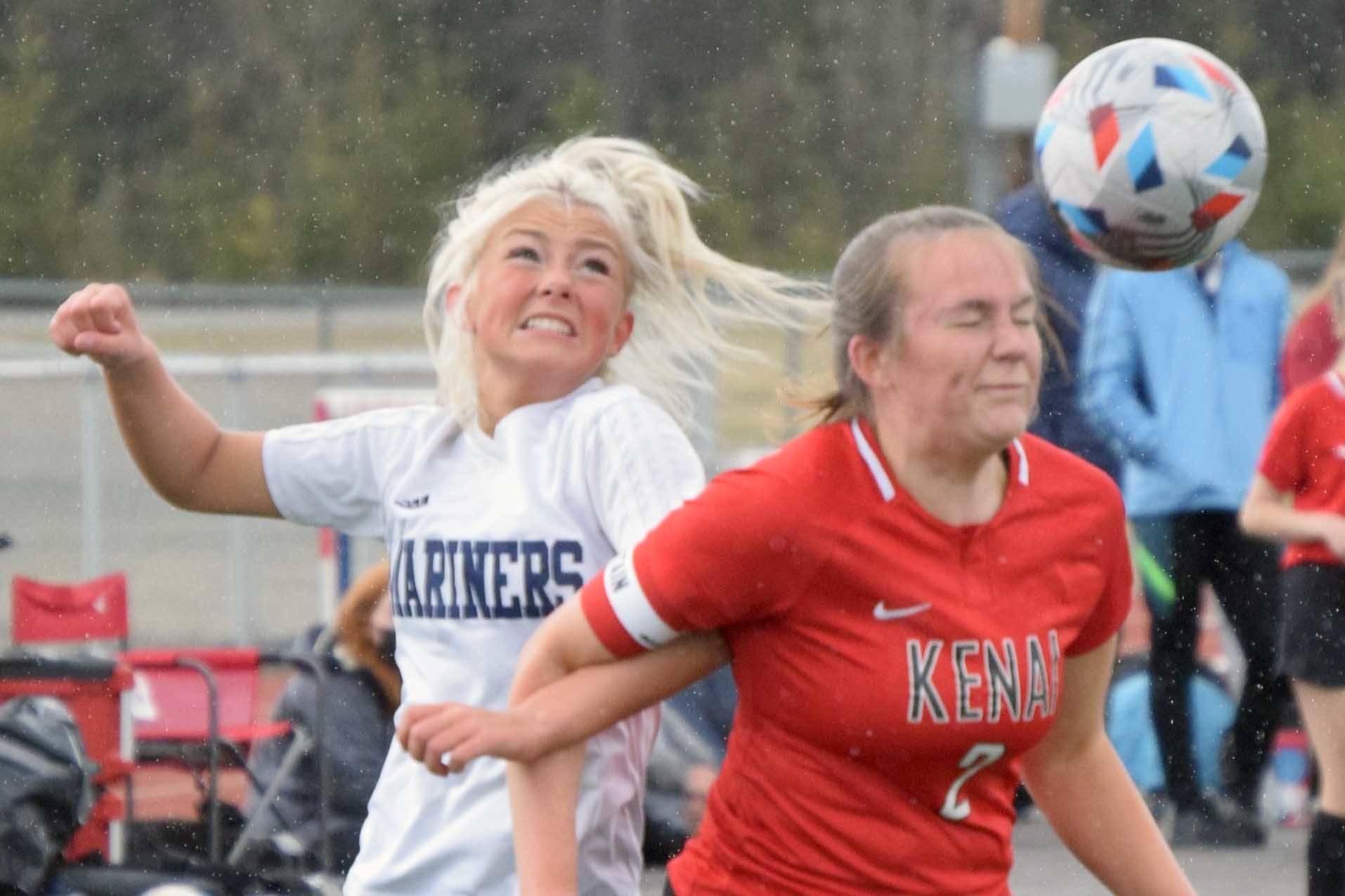 Homer's Sela Weisser and Kenai's Bethany Morris battle for the ball Friday, May 21, 2021, in the Peninsula Conference semifinals at Kenai Central High School in Kenai, Alaska. (Photo by Jeff Helminiak/Peninsula Clarion)