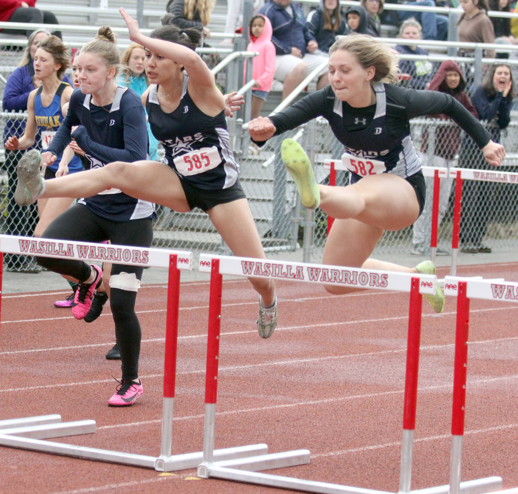 Soldotna’s Angelina Chavarria and Emma Brantley clear a hurdle during the Division I girls 100-meter hurdles in the Region 3 Championshps on Saturday, May 22, 2021, at Wasilla High School. (Photo by Jeremiah Bartz/Frontiersman)