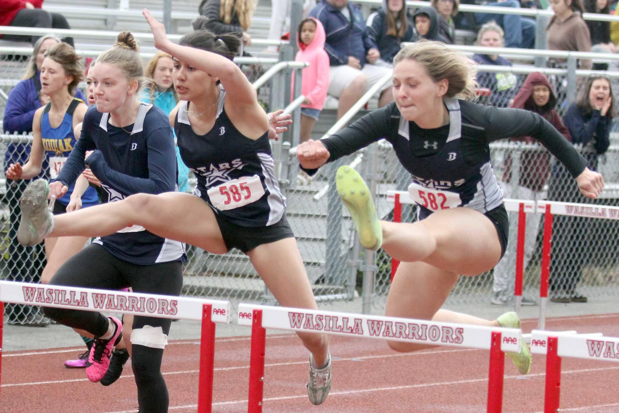 Soldotna’s Angelina Chavarria and Emma Brantley clear a hurdle during the Division I girls 100-meter hurdles in the Region 3 Championshps on Saturday, May 22, 2021, at Wasilla High School. (Photo by Jeremiah Bartz/Frontiersman)
