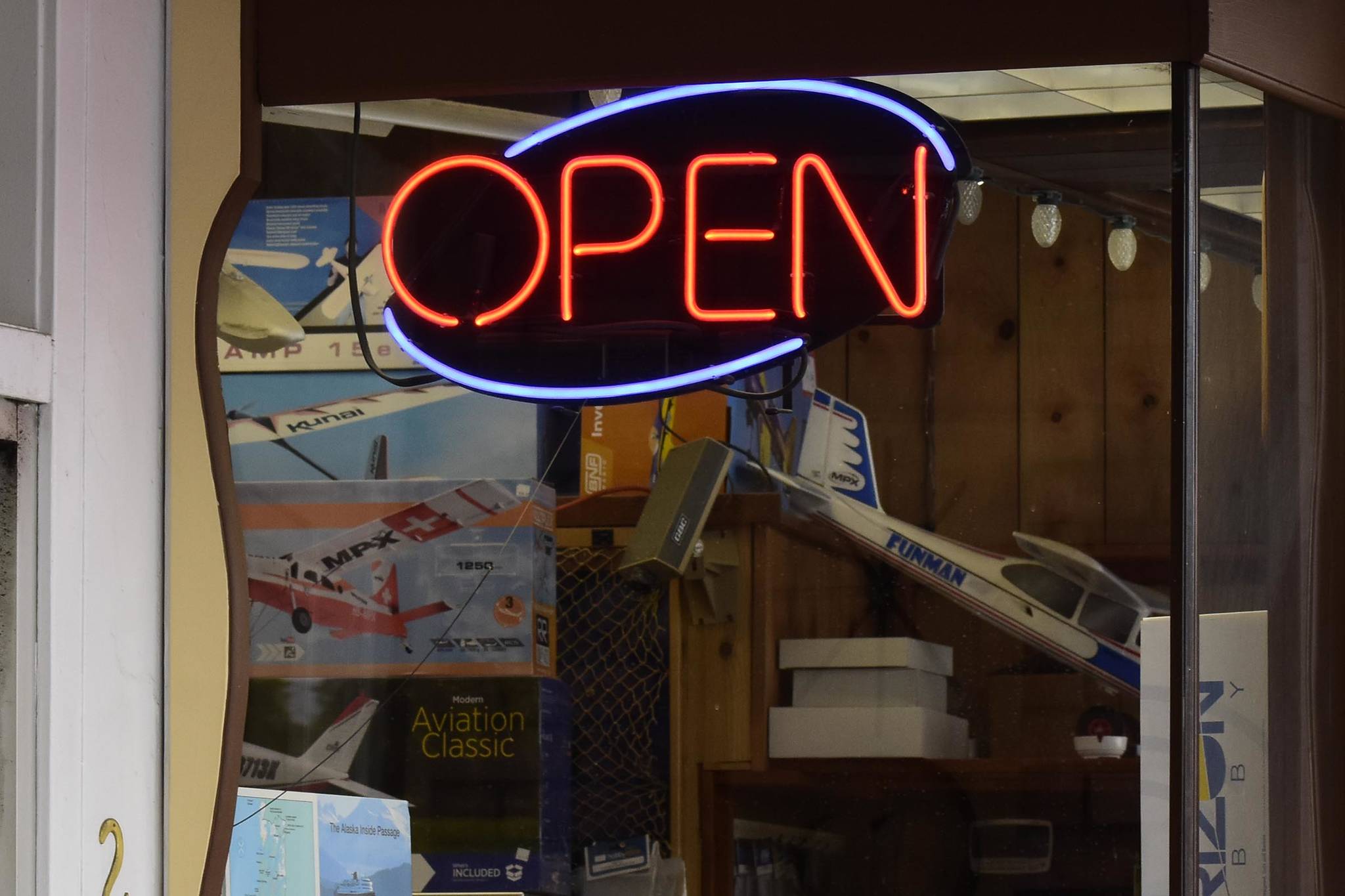 This May 2020 photo shows an open sign illuminated on a Juneau business. Alaska Department of Labor and Workforce Development reports the state has added jobs but has not yet returned to pre-pandemic levels of employment. (Peter Segall / Juneau Empire File)