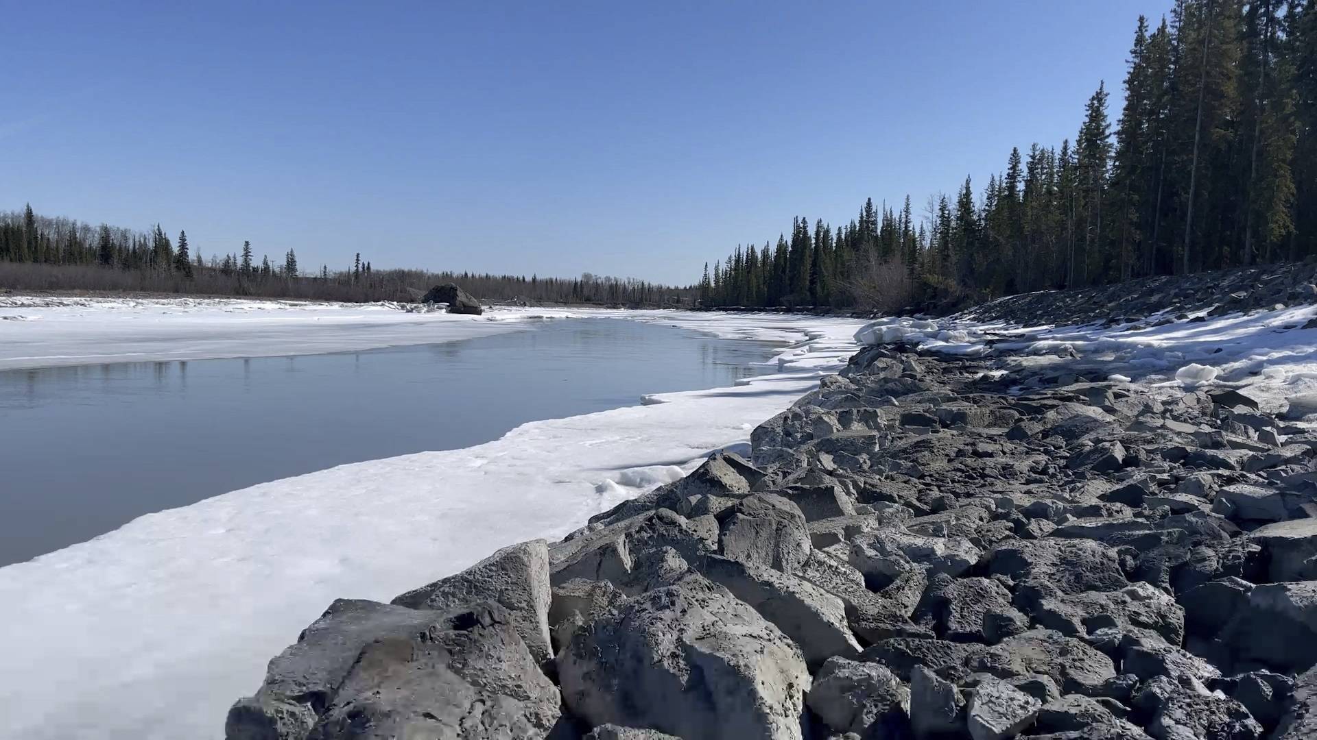 In this April 22, 2021, photo, signs of spring thaw appear along the Tazlina River in Tazlina, Alaska. The Catholic Church wants to sell 462 acres that once housed the Copper Valley mission school to the Native Village of Tazlina, a federally recognized tribe. The tribe is scrambling to raise the nearly $1.9 million asking price so it can regain stewardship of its ancestral land. (John Tierney / Indian Country Today)