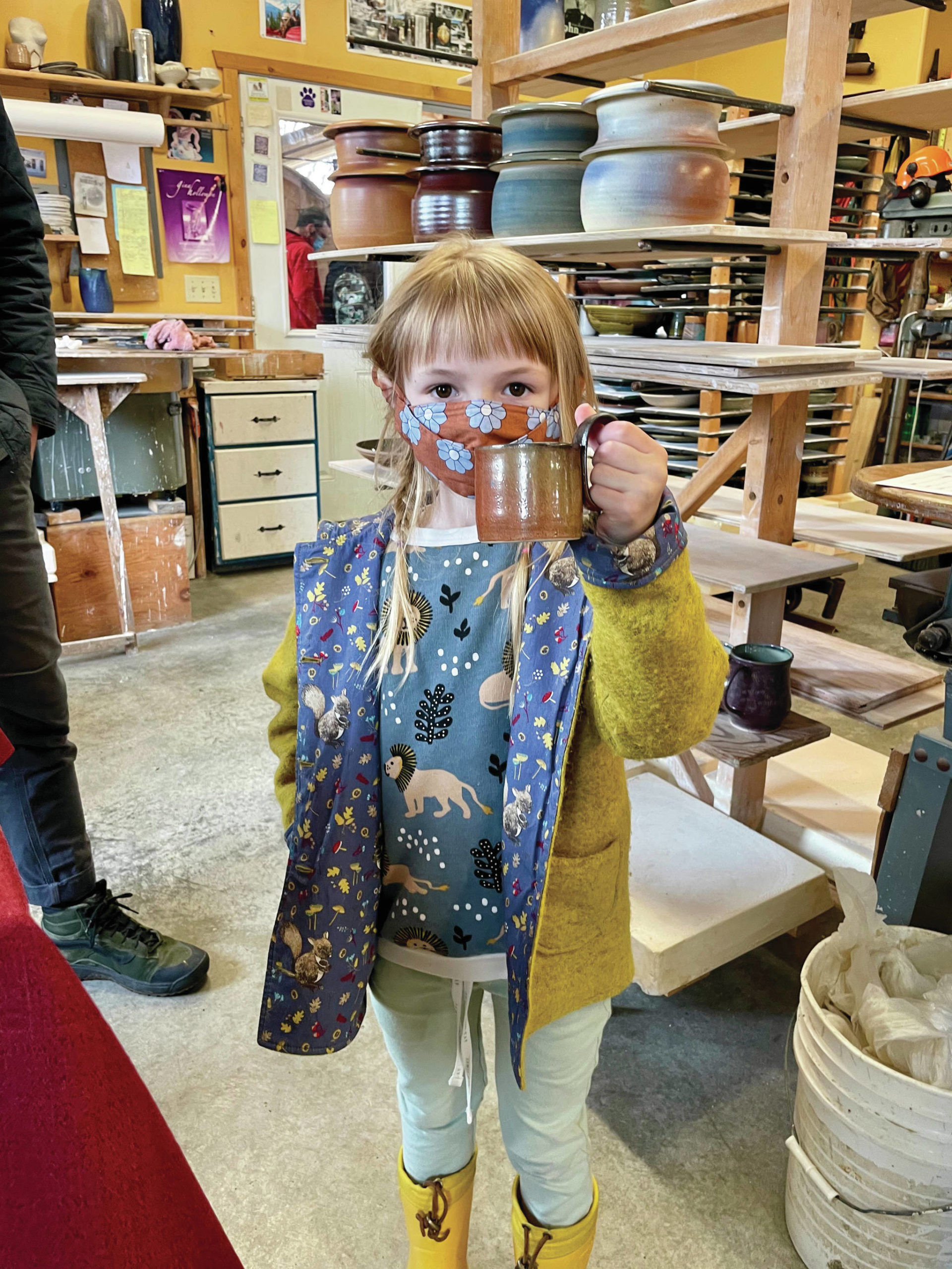 Photo by David Kaufman
Lulu Hawkins, age 6, holds up her pottery tour purchase — a David Kaufmann mug — at his studio in Homer on May 15.