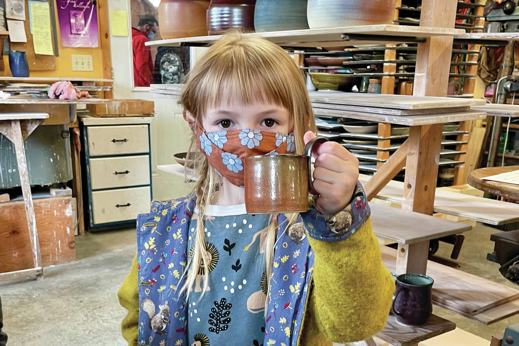 On Saturday, May 15, 2021, Lulu Hawkins, age 6 holds up her pottery tour purchase: a David Kaufmann mug at his studio in Homer, Alaska. (Photo by David Kaufman)