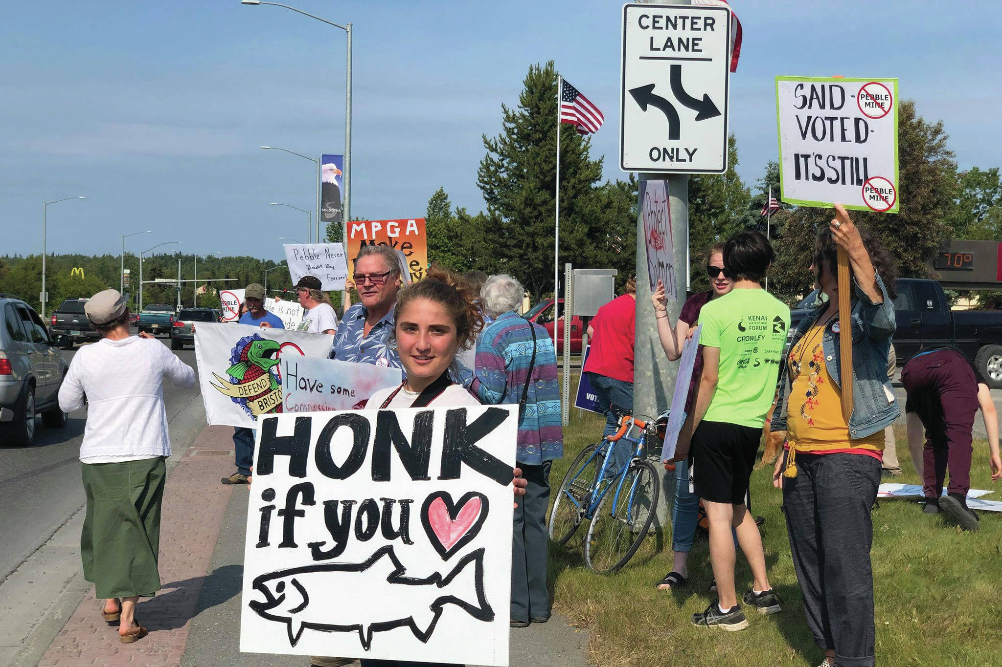 Residents line the Sterling Highway, in front of Sen. Lisa Murkowski’s office to oppose Pebble mine on Wednesday, June 26, 2019, in Soldotna, Alaska. (Photo by Victoria Petersen/Peninsula Clarion)