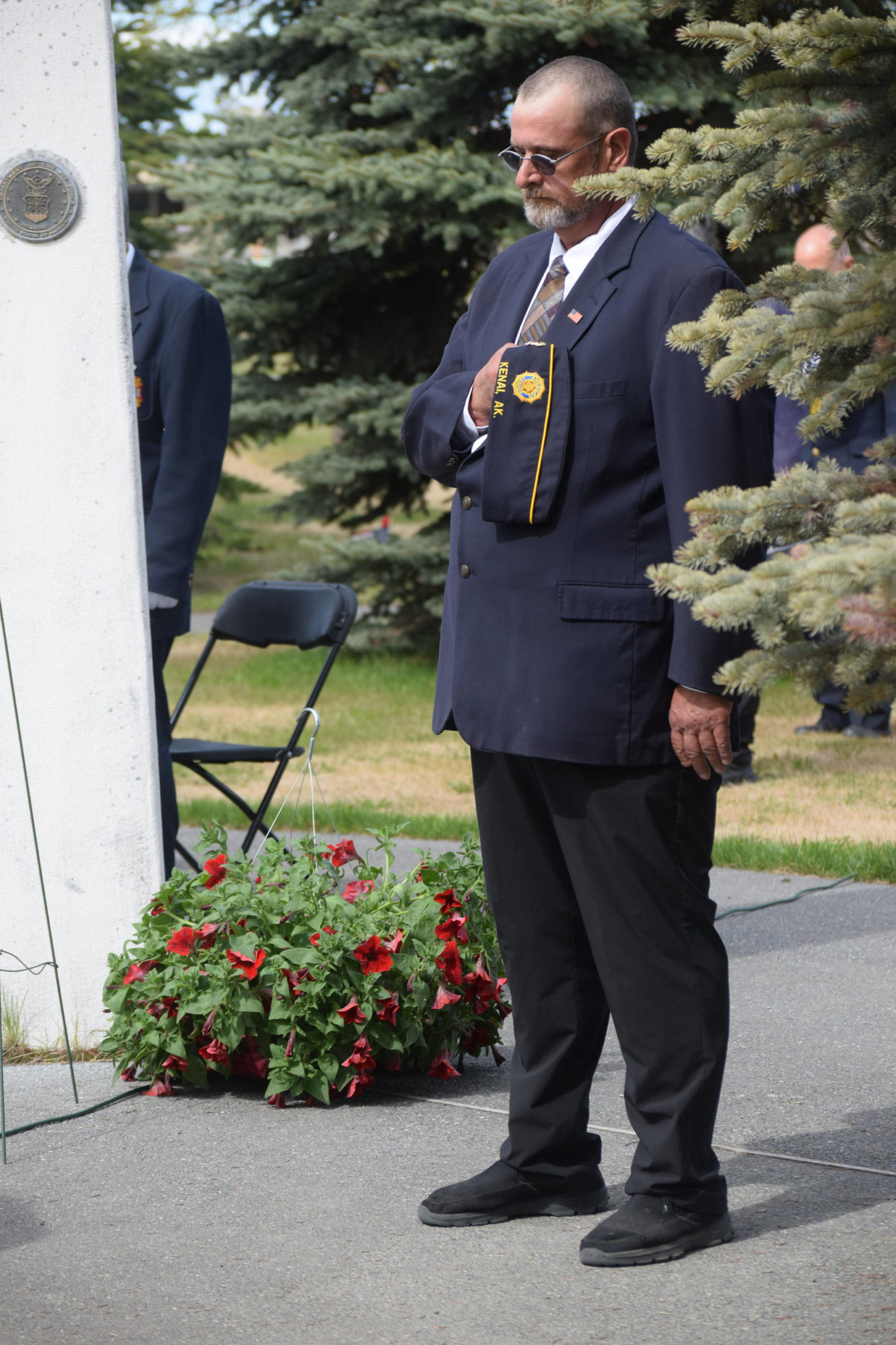 Commander David Segura bows his head during the opening invocation of the Memorial Day ceremony at Leif Hansen Memorial Park in Kenai, Alaska, on Monday, May 31, 2021. (Camille Botello/Peninsula Clarion)