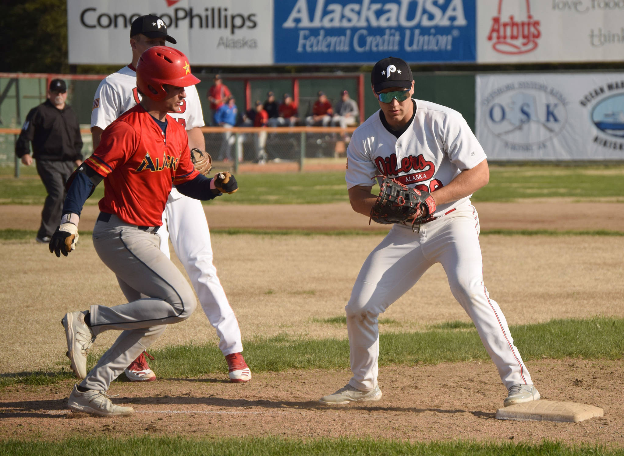 Peninsula Oilers first baseman Cole Hage forces out Marco Pirruccello of the Alaska Goldpanners of Fairbanks on Monday, June 7, 2021, at Coral Seymour Memorial Park in Kenai, Alaska. (Photo by Jeff Helminiak/Peninsula Clarion)