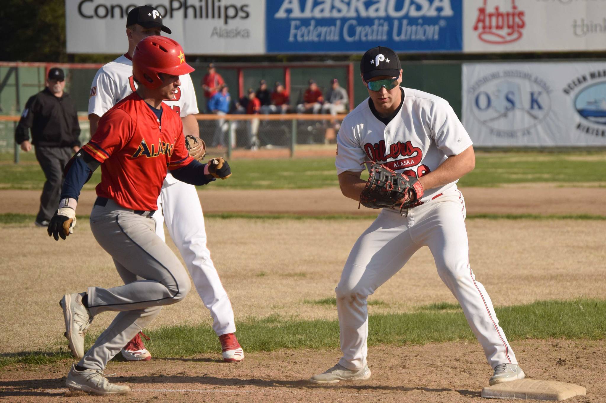 Peninsula Oilers first baseman Cole Hage forces out Marco Pirruccello of the Alaska Goldpanners of Fairbanks on Monday, June 7, 2021, at Coral Seymour Memorial Park in Kenai, Alaska. (Photo by Jeff Helminiak/Peninsula Clarion)