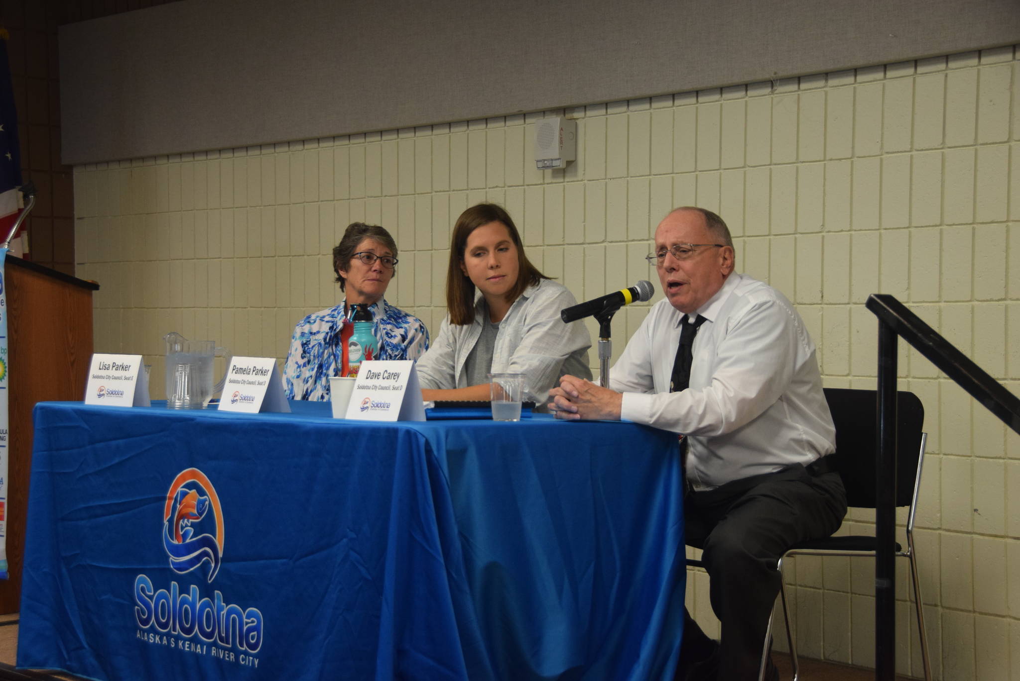Then-candidates for Soldotna City Council Lisa Parker, Pamela Parker (center) and Dave Carey speak to members of the Soldotna Chamber of Commerce at the Soldotna Sports Complex on Sept. 11, 2019. Parker resigned her seat effective May 27. (Photo by Brian Mazurek/Peninsula Clarion)