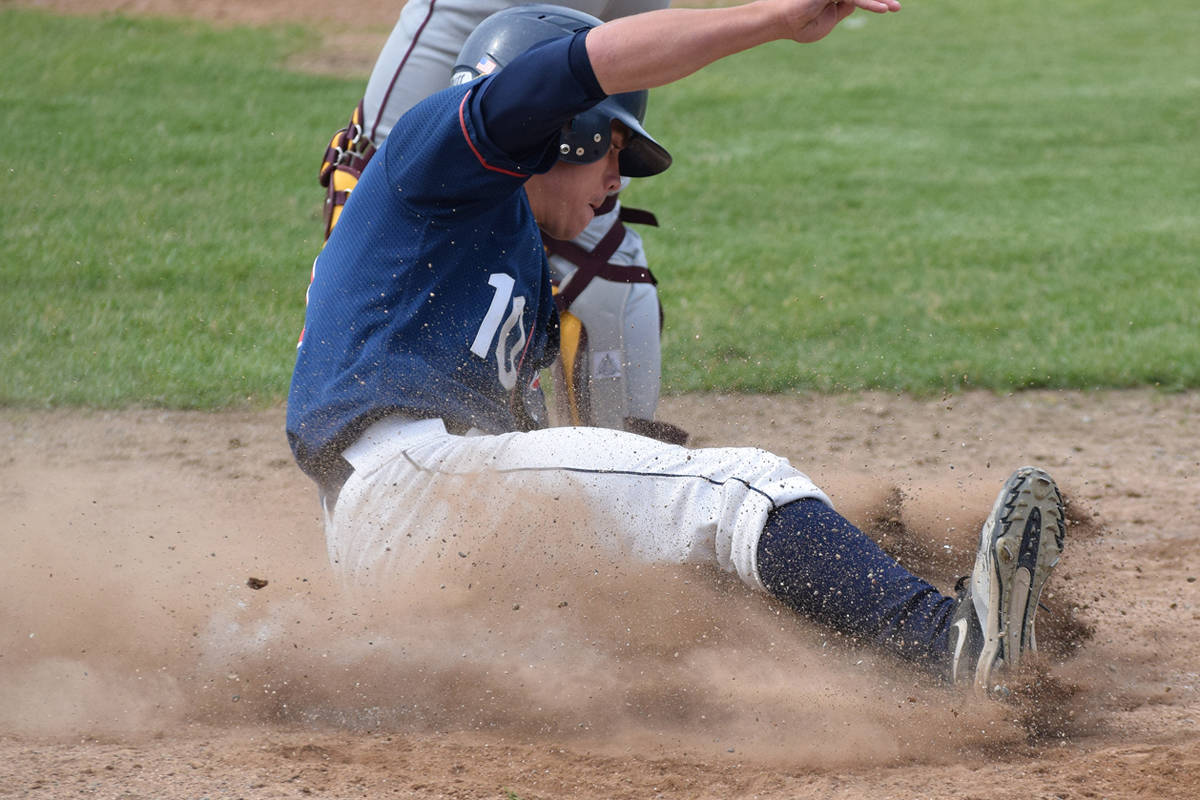 Clarion Post 20 Twins shortstop Josh Darrow slides into home plate to score in July 2019 at the Kenai Little League fields. (Clarion file photo)
