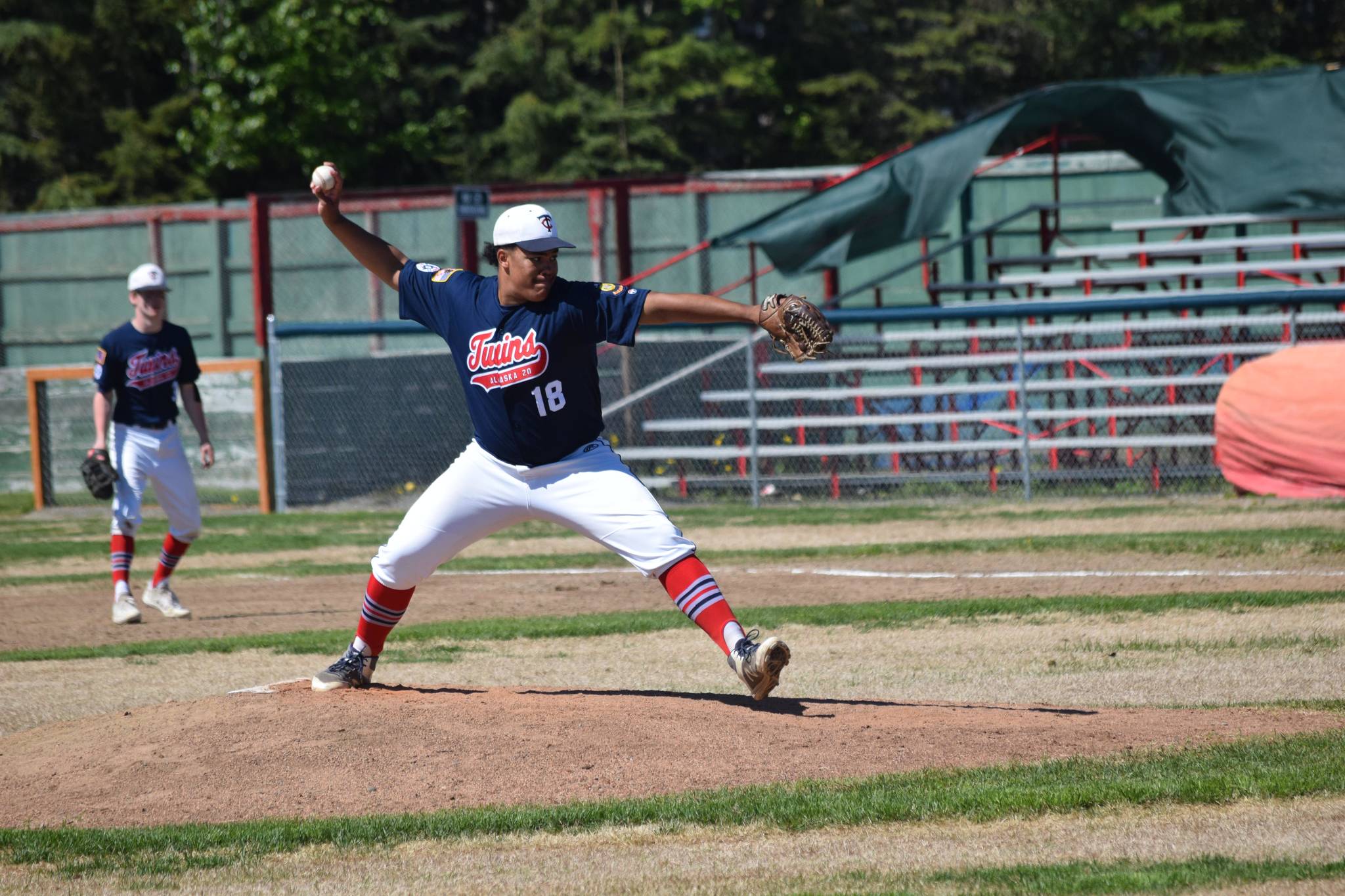 Atticus Gibson fires off a pitch during Kenai’s league game against East Anchorage at Oiler Park on Sunday, June 13, 2021. (Camille Botello / Peninsula Clarion)