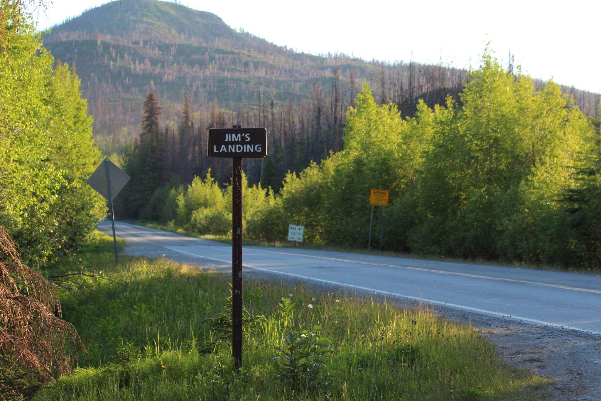 A sign indicates the turn for Jims’ Landing on Skilak Lake Road on Sunday, June 13, 2021 near Skilak Lake on the Kenai Peninsula in Alaska. (Ashlyn O’Hara/Peninsula Clarion)